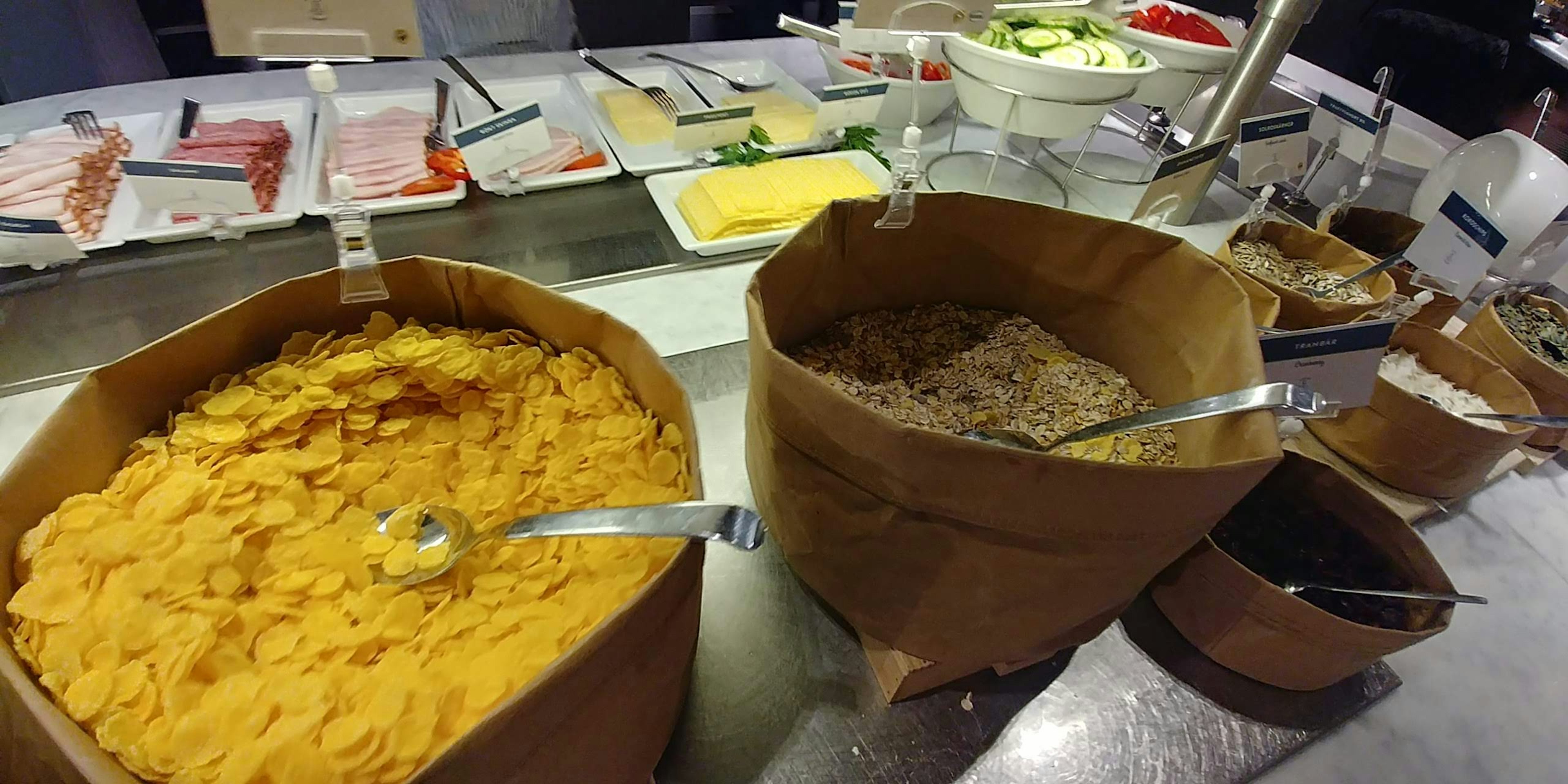 Buffet-style food section with colorful ingredients in bowls