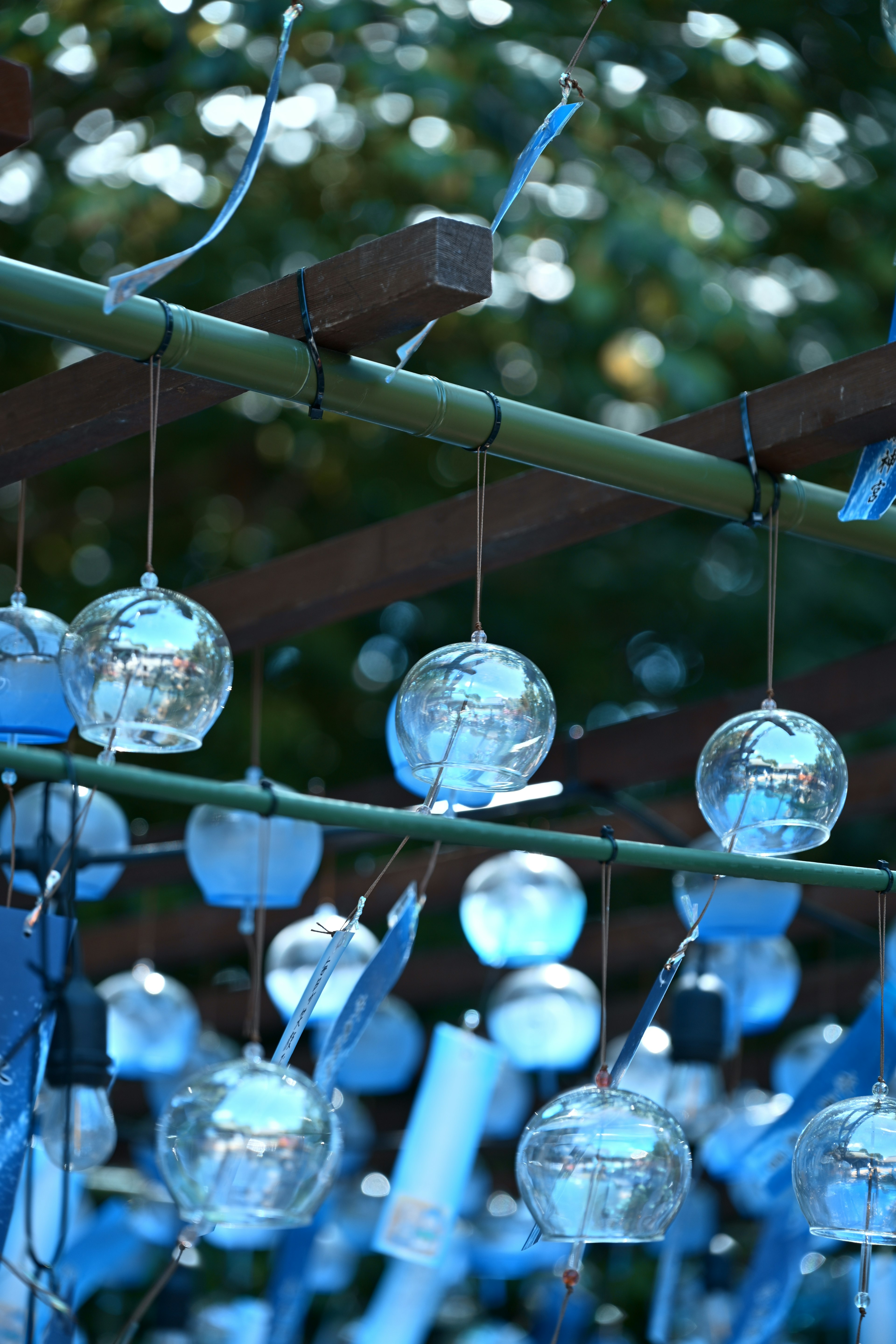 Blue glass wind chimes hanging in a serene setting