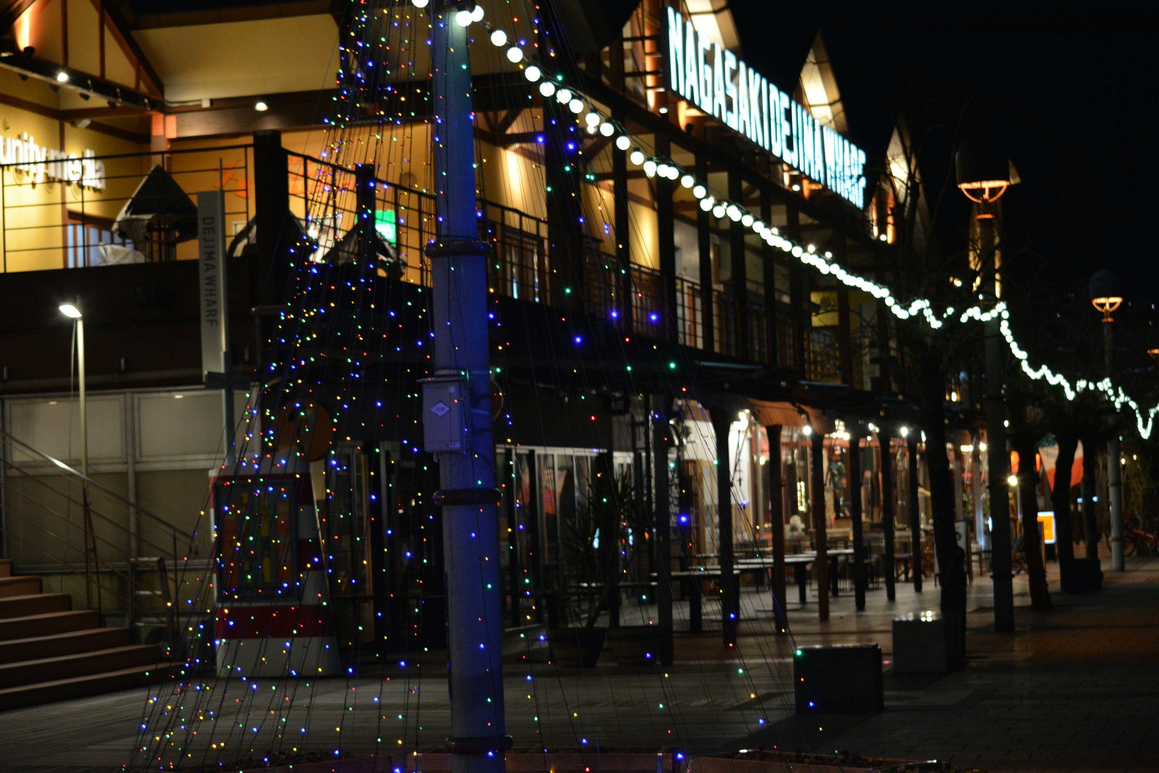 Nighttime street scene with colorful lights and buildings