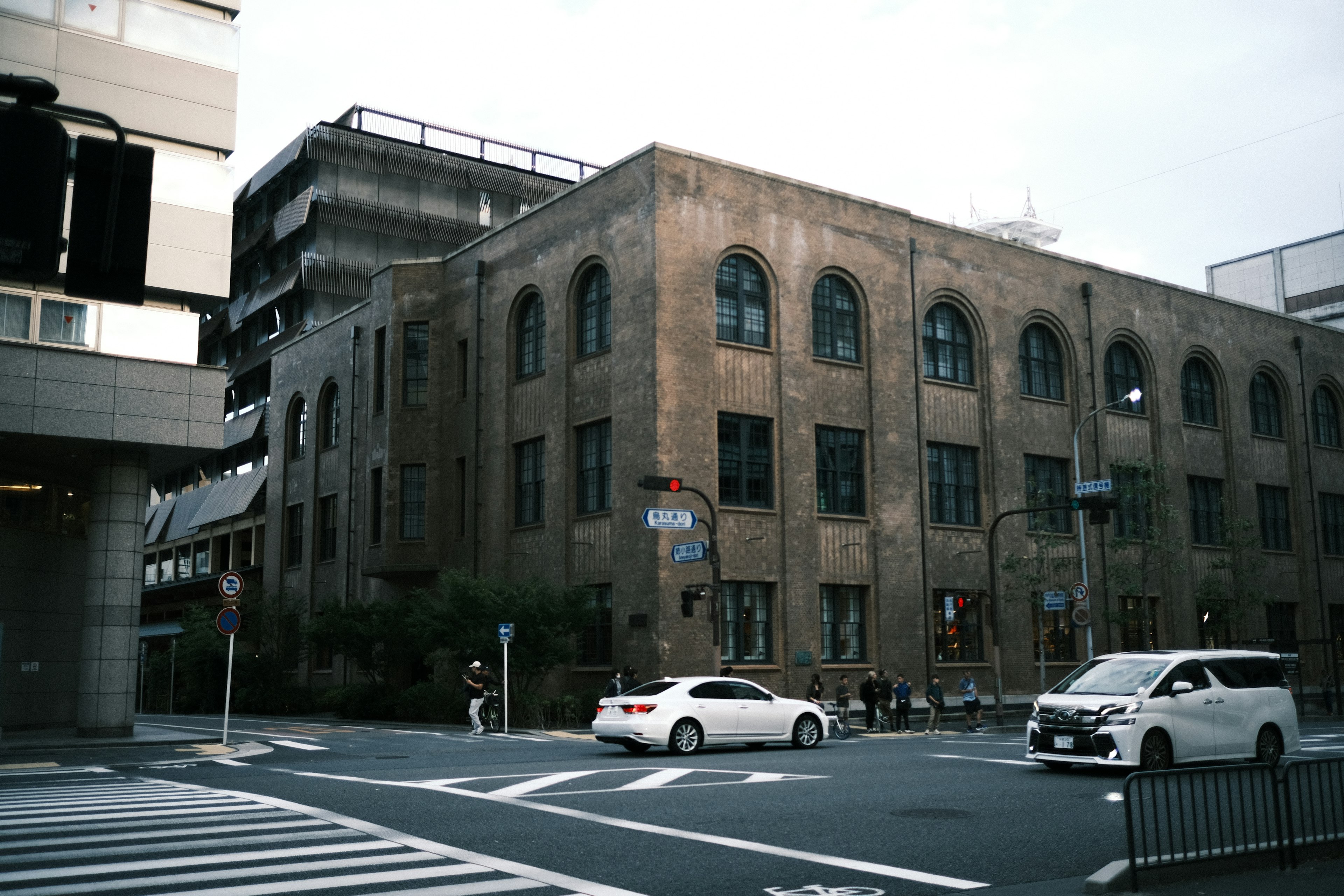 Historic brick building at a city intersection modern architecture in the background