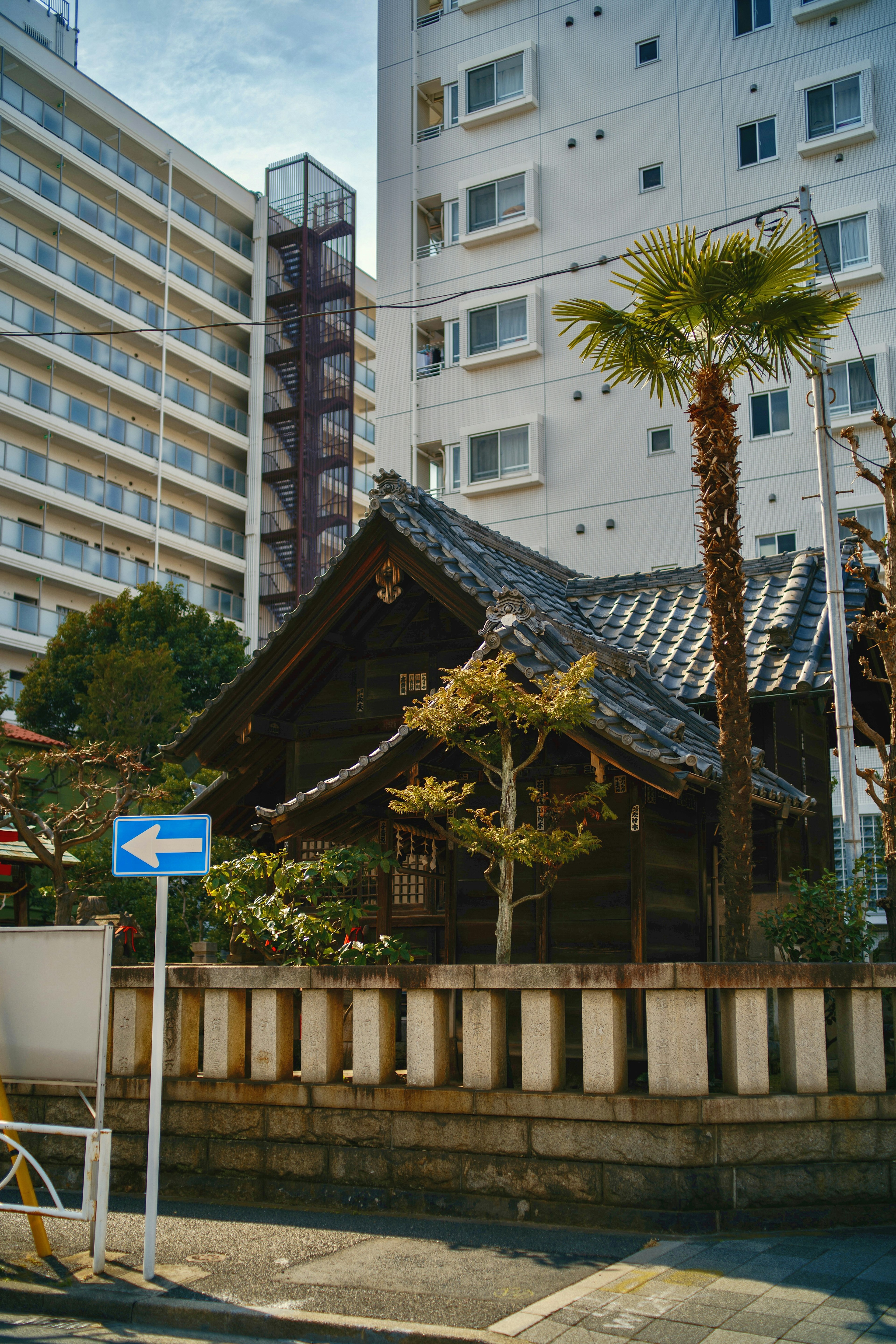 Edificio japonés tradicional con jardín entre edificios altos