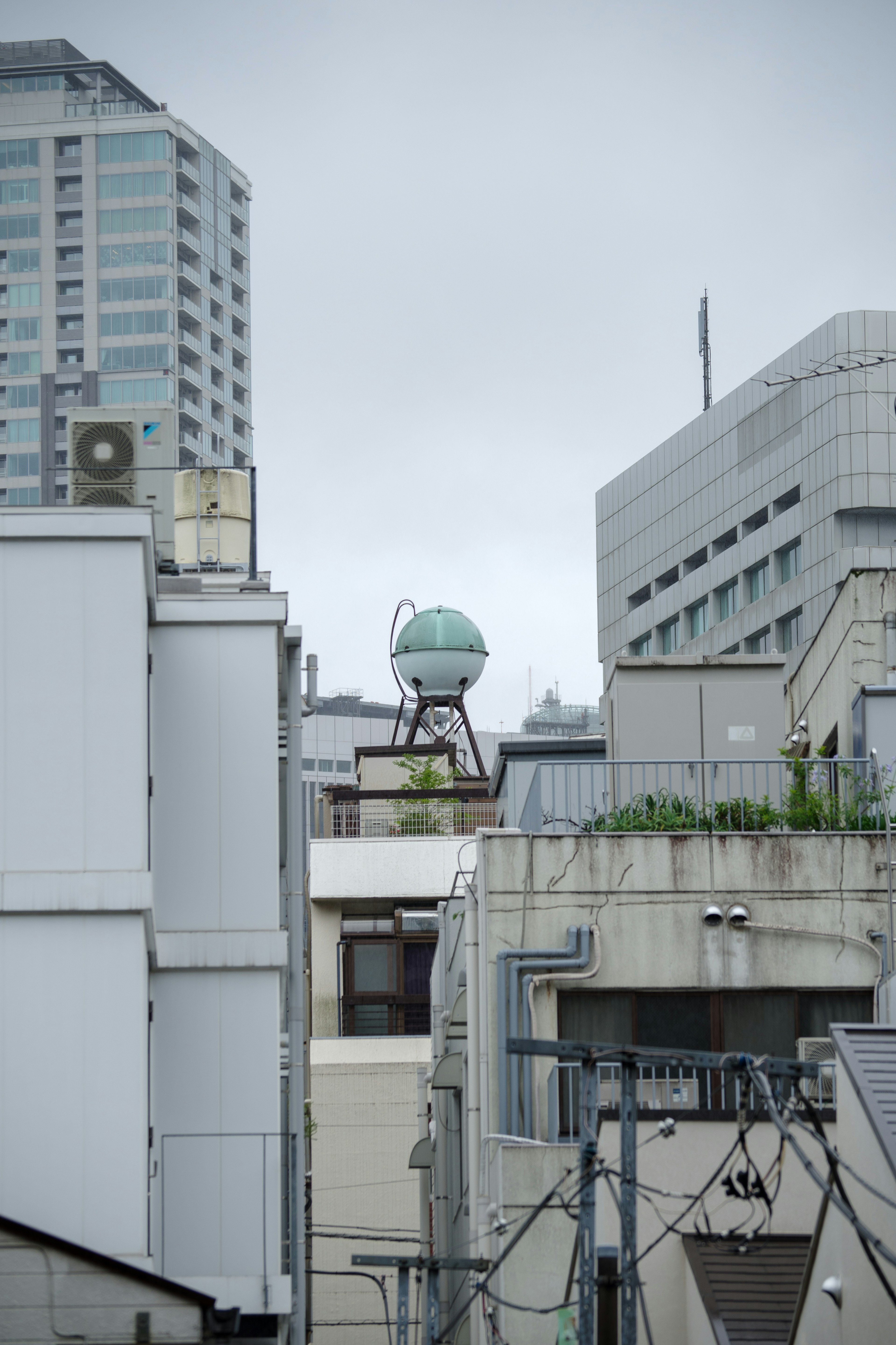 A blue globe-like object situated among urban buildings