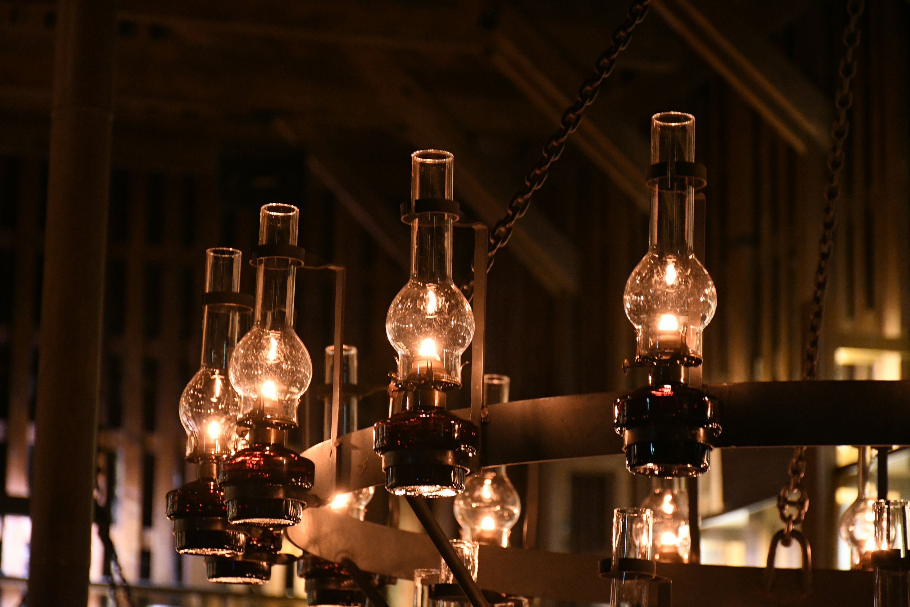 Beautiful chandelier with hanging oil lamps and warm light