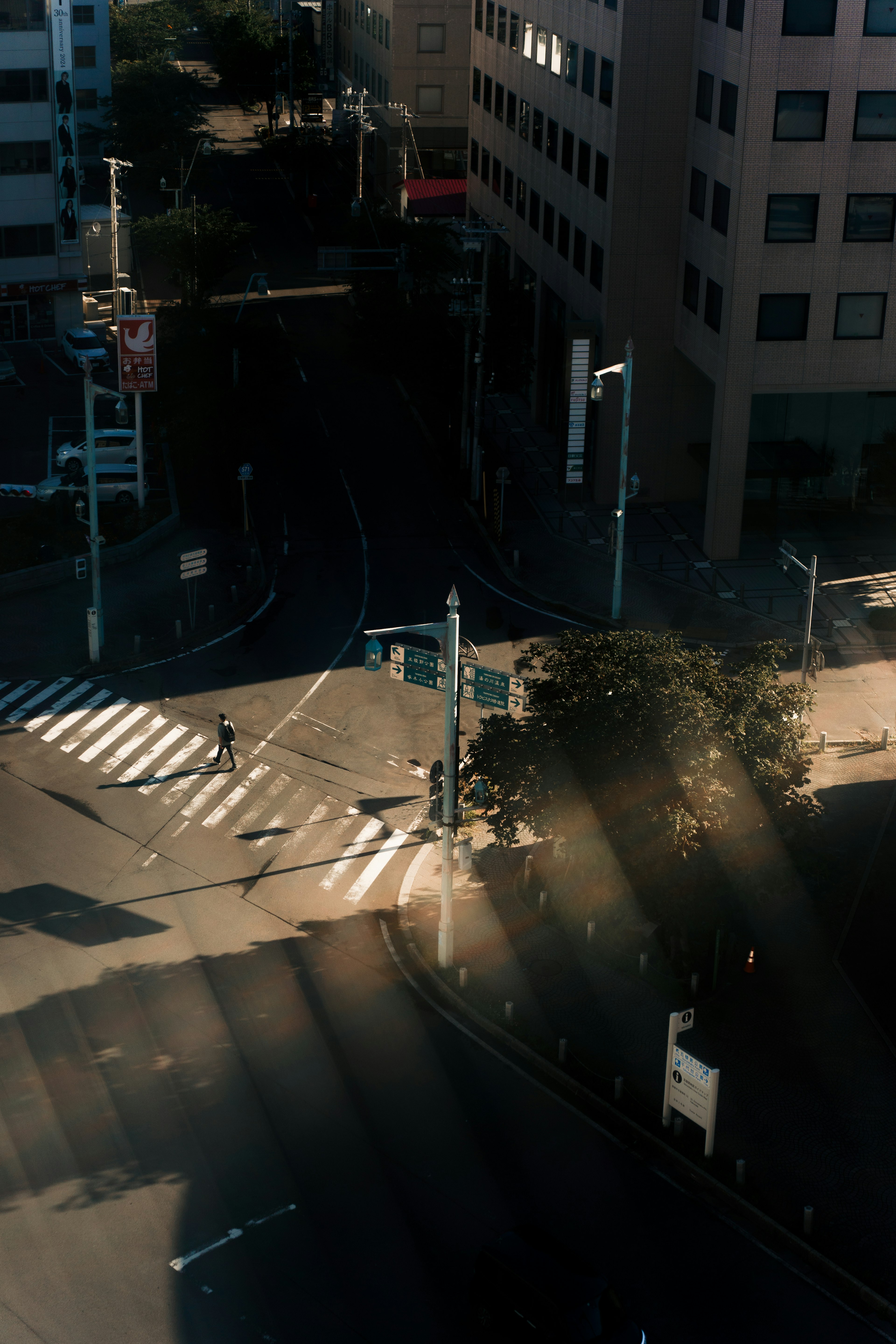 Aerial view of an intersection with long shadows from buildings