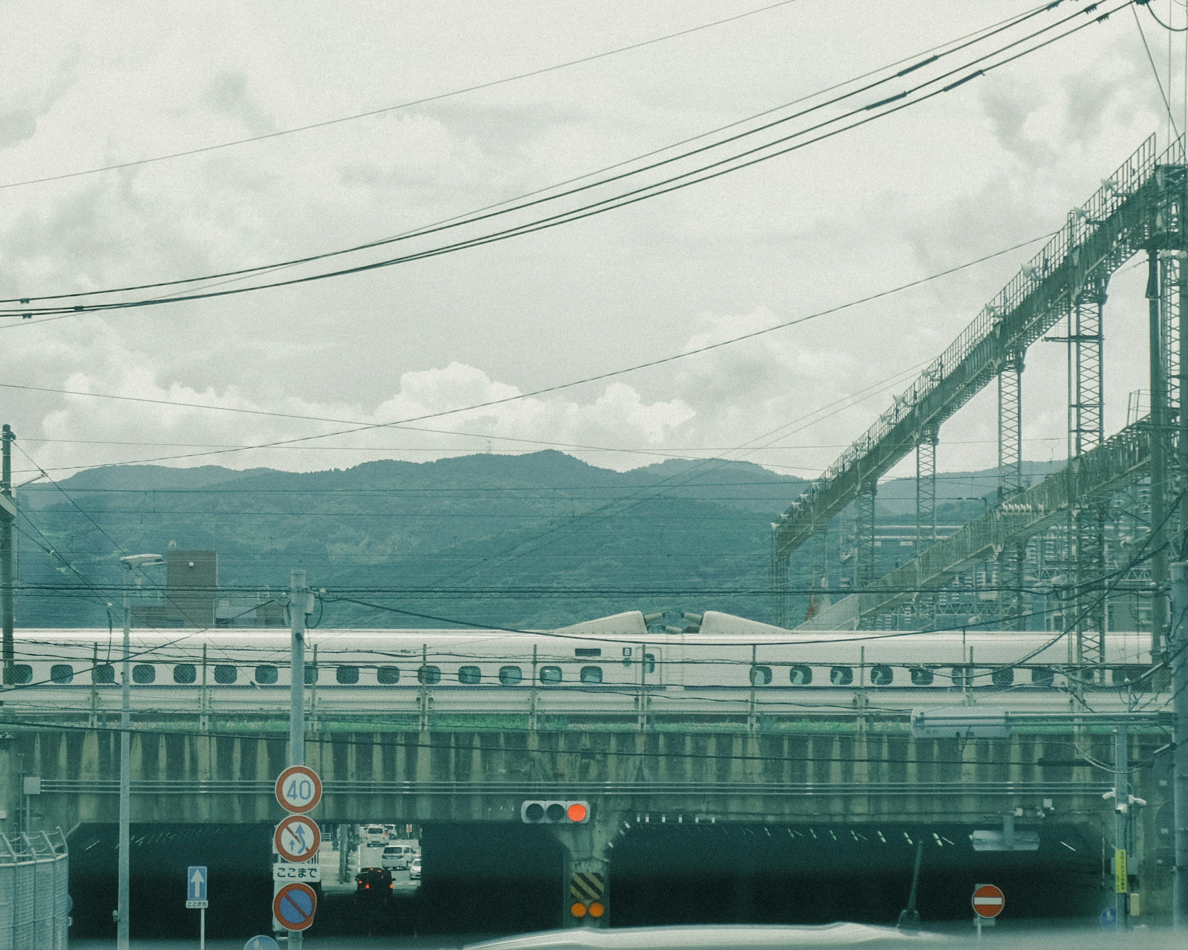 Railway station with tracks and mountains in the background