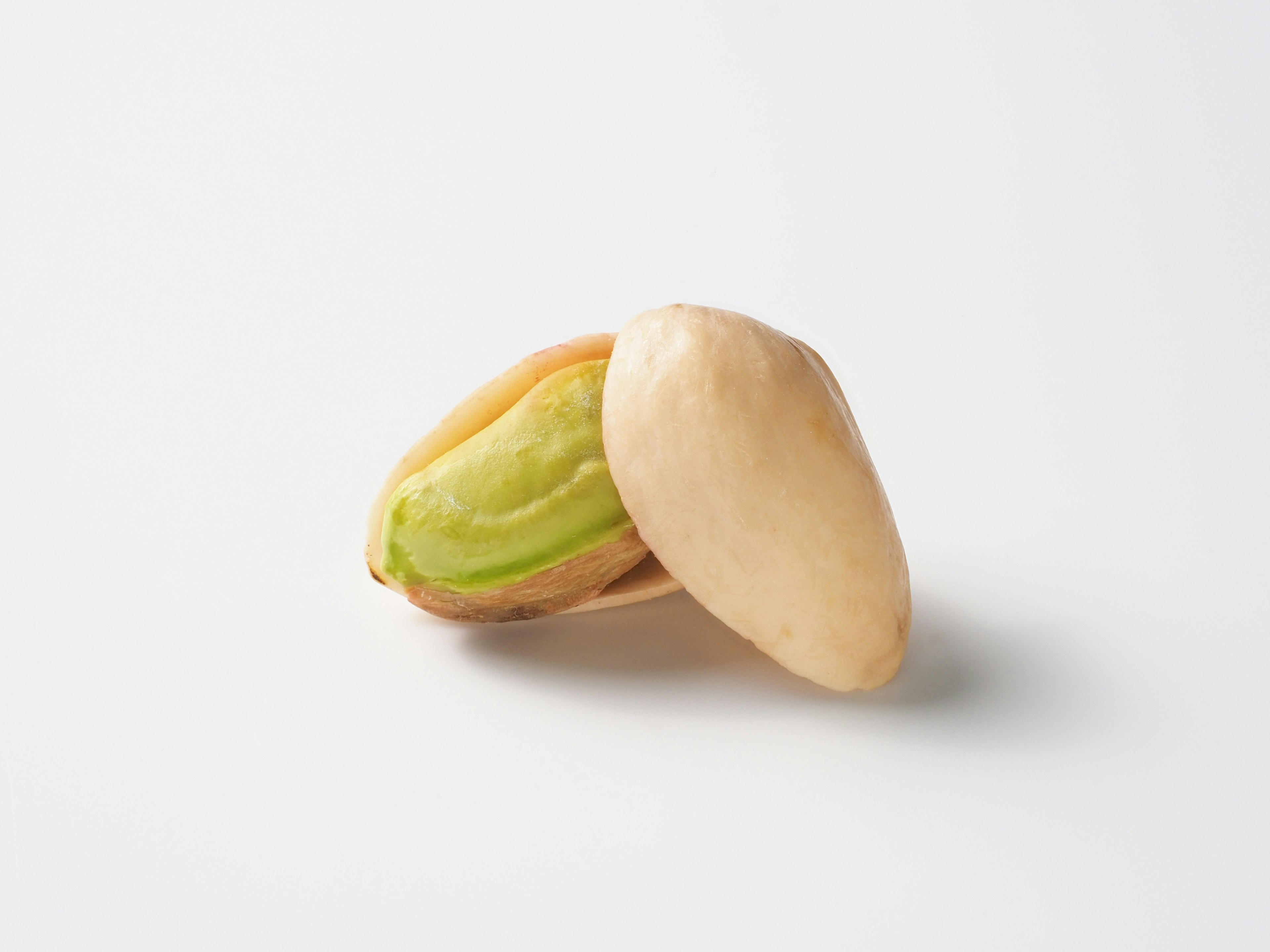 Open pistachio nut revealing the green kernel inside