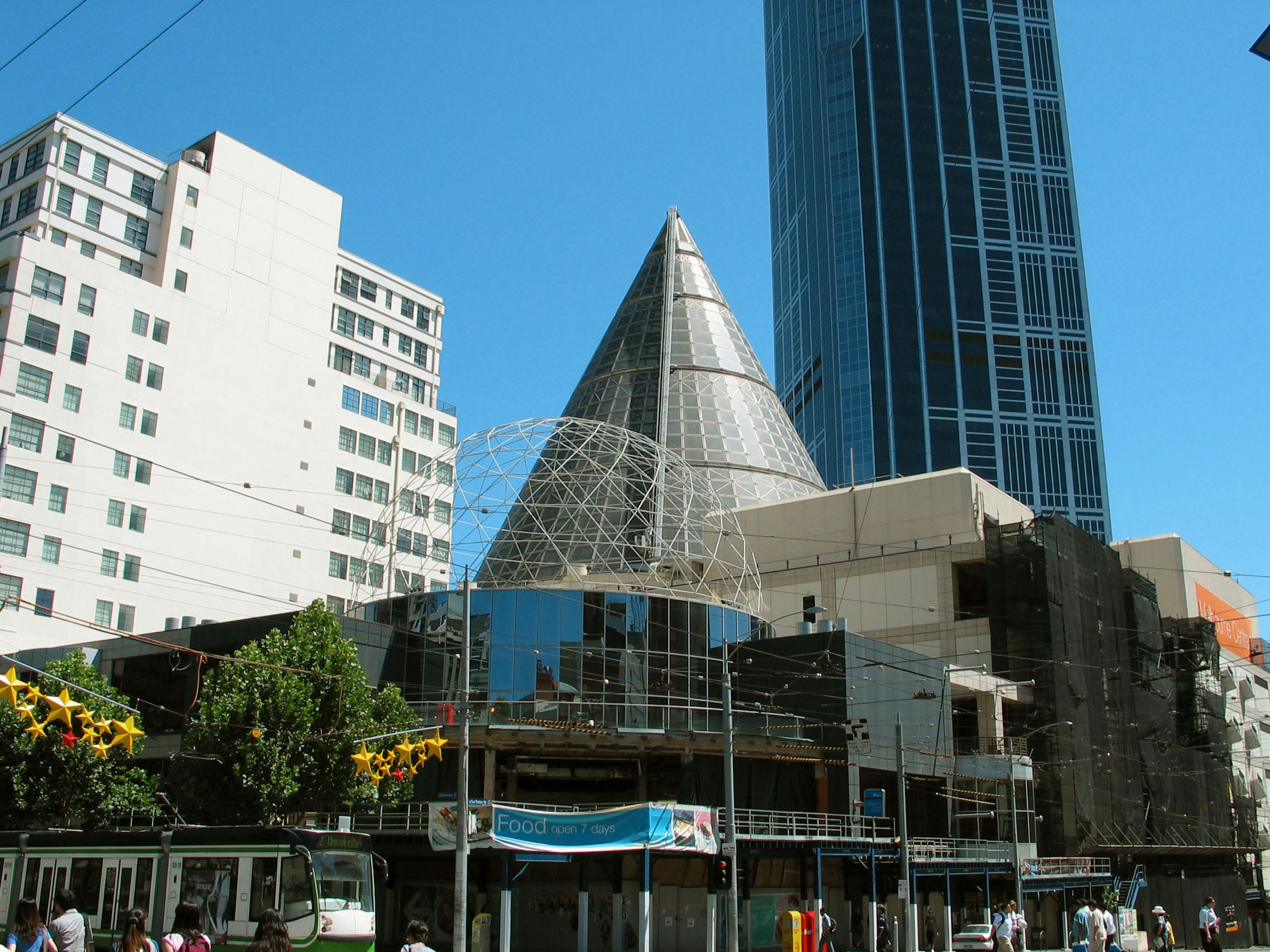 Urban buildings featuring a modern pyramid-shaped roof