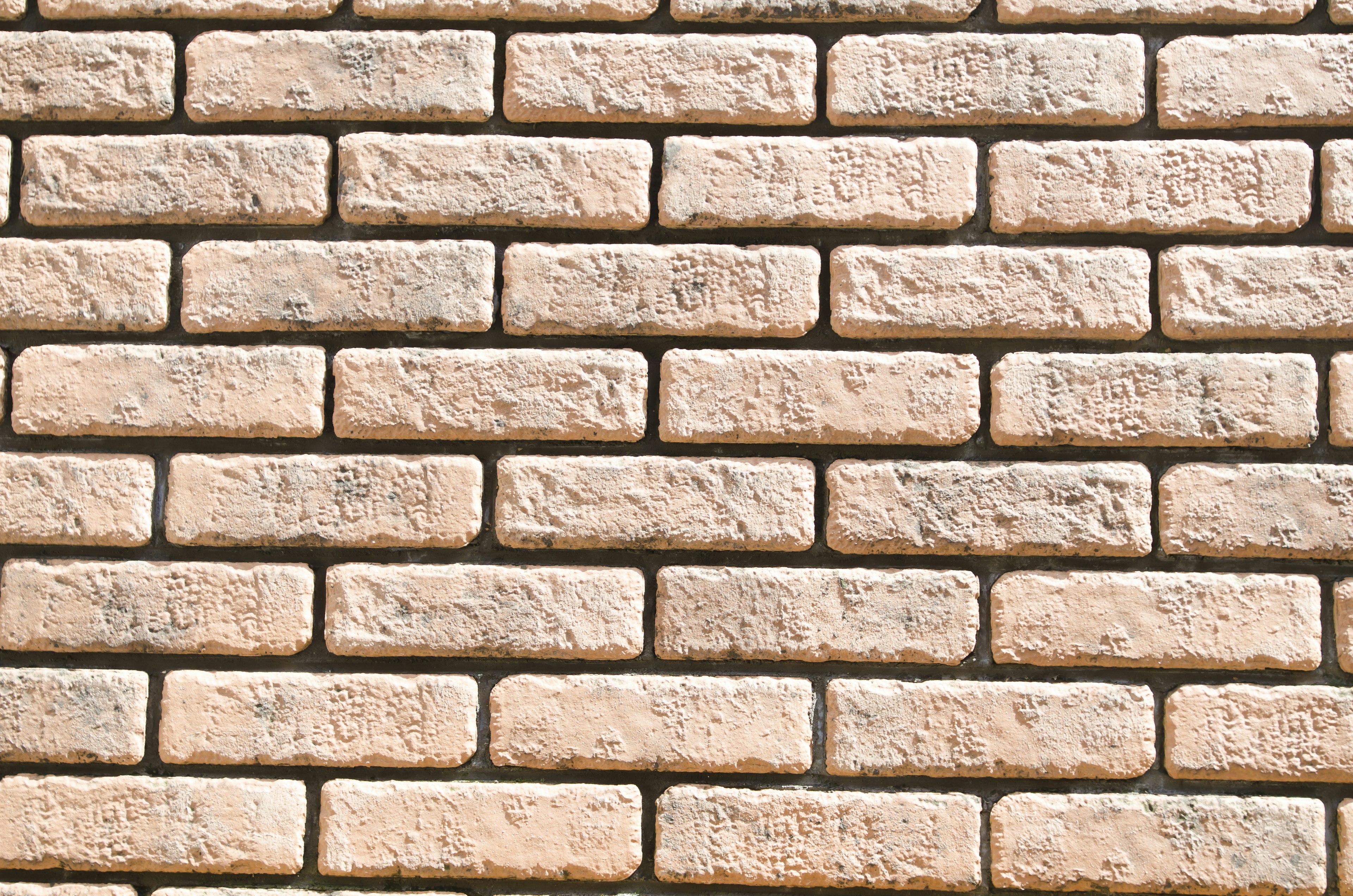 Textured wall made of light-colored bricks