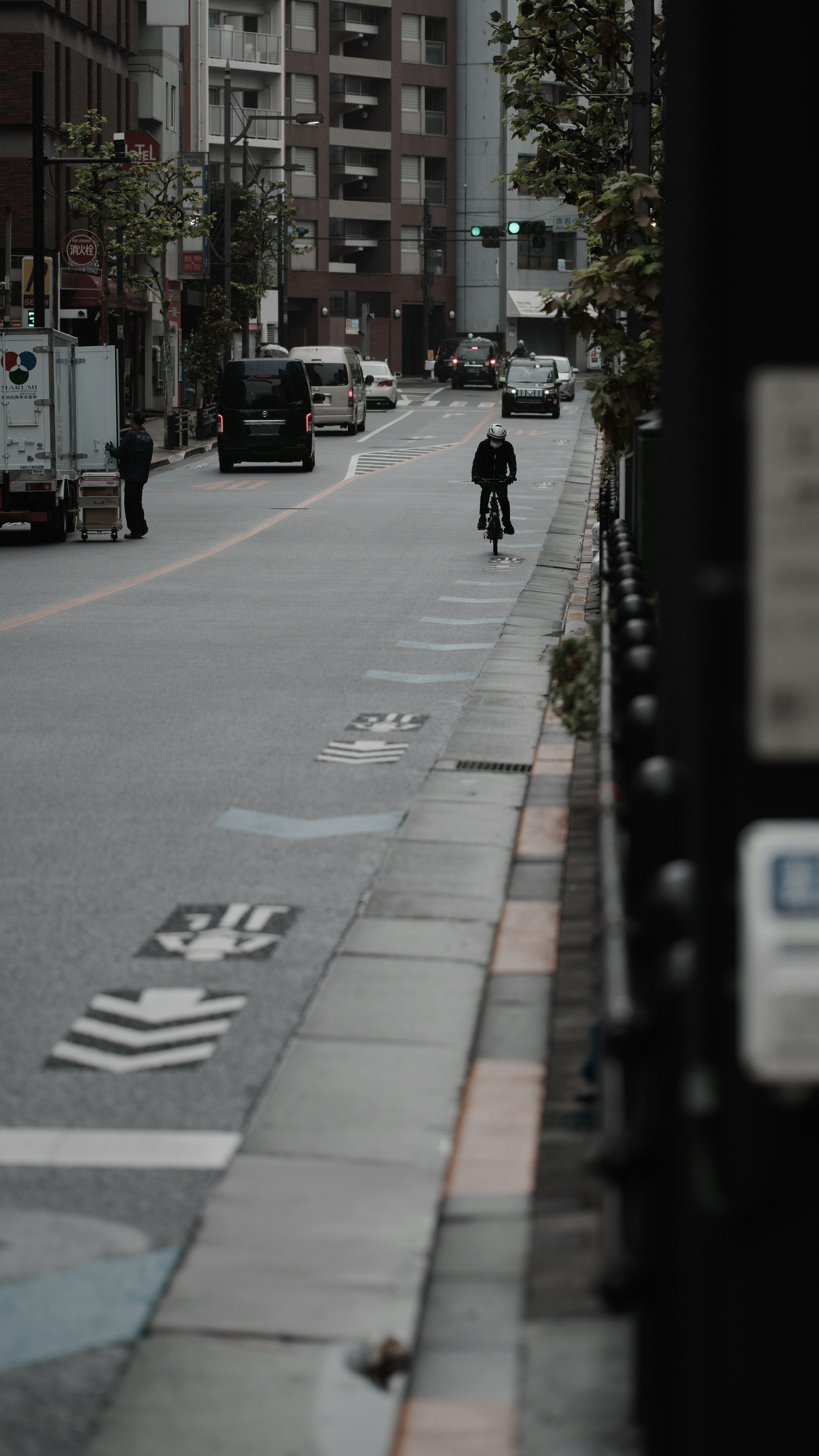 自転車に乗る人物がいる都市の通りの風景