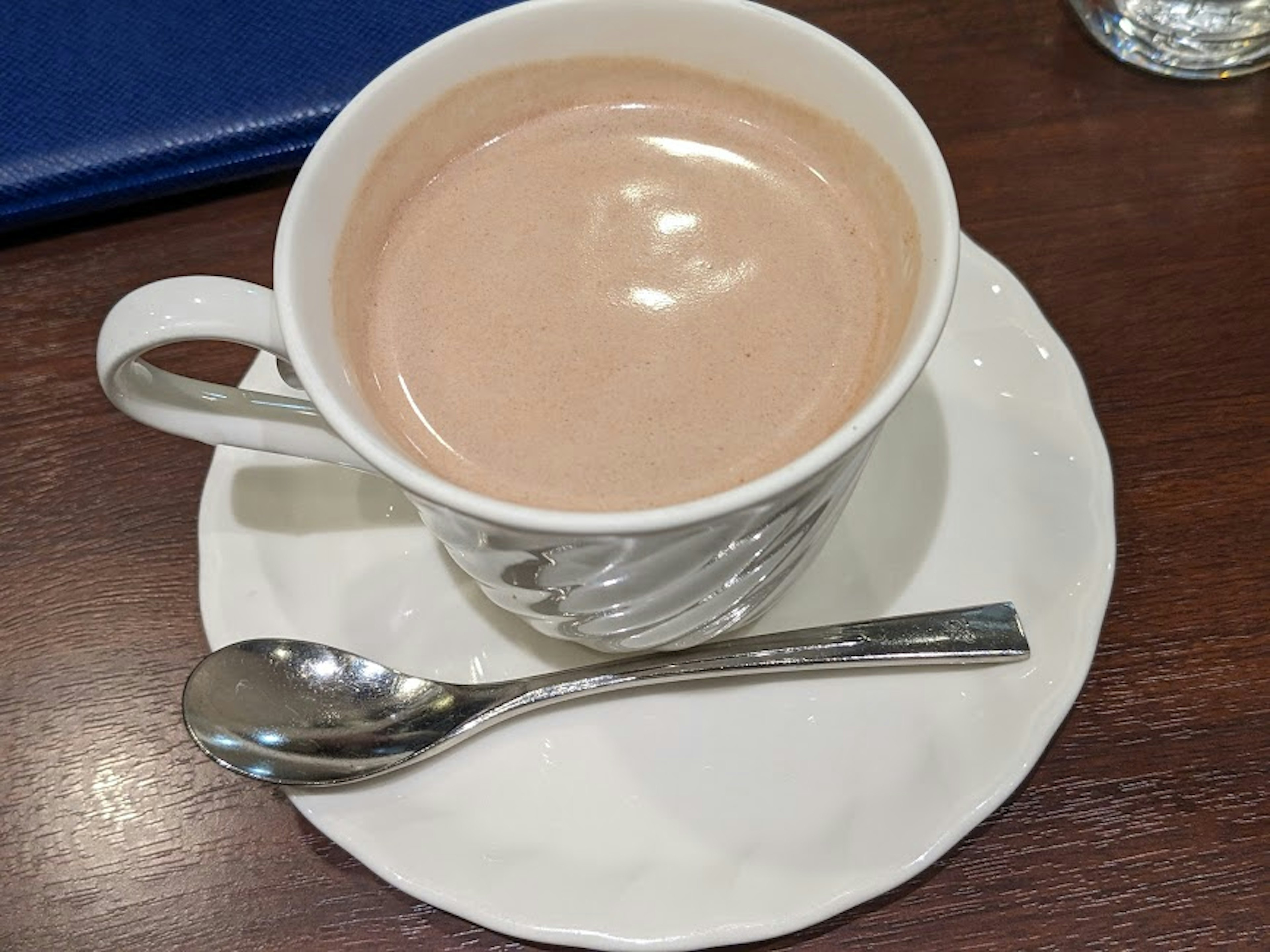 Creamy hot chocolate in a white cup