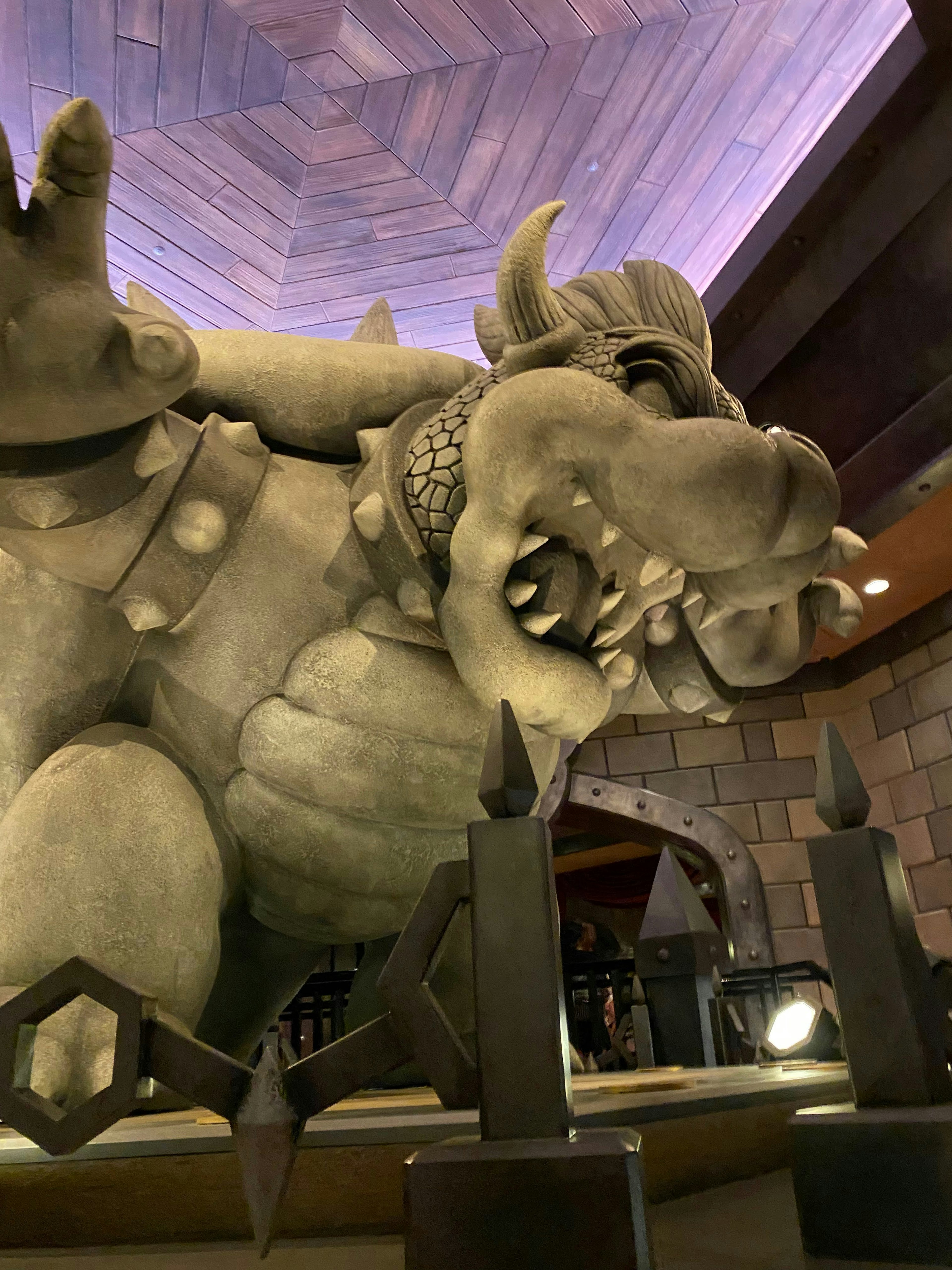 Large stone dragon statue with an open mouth in an indoor setting