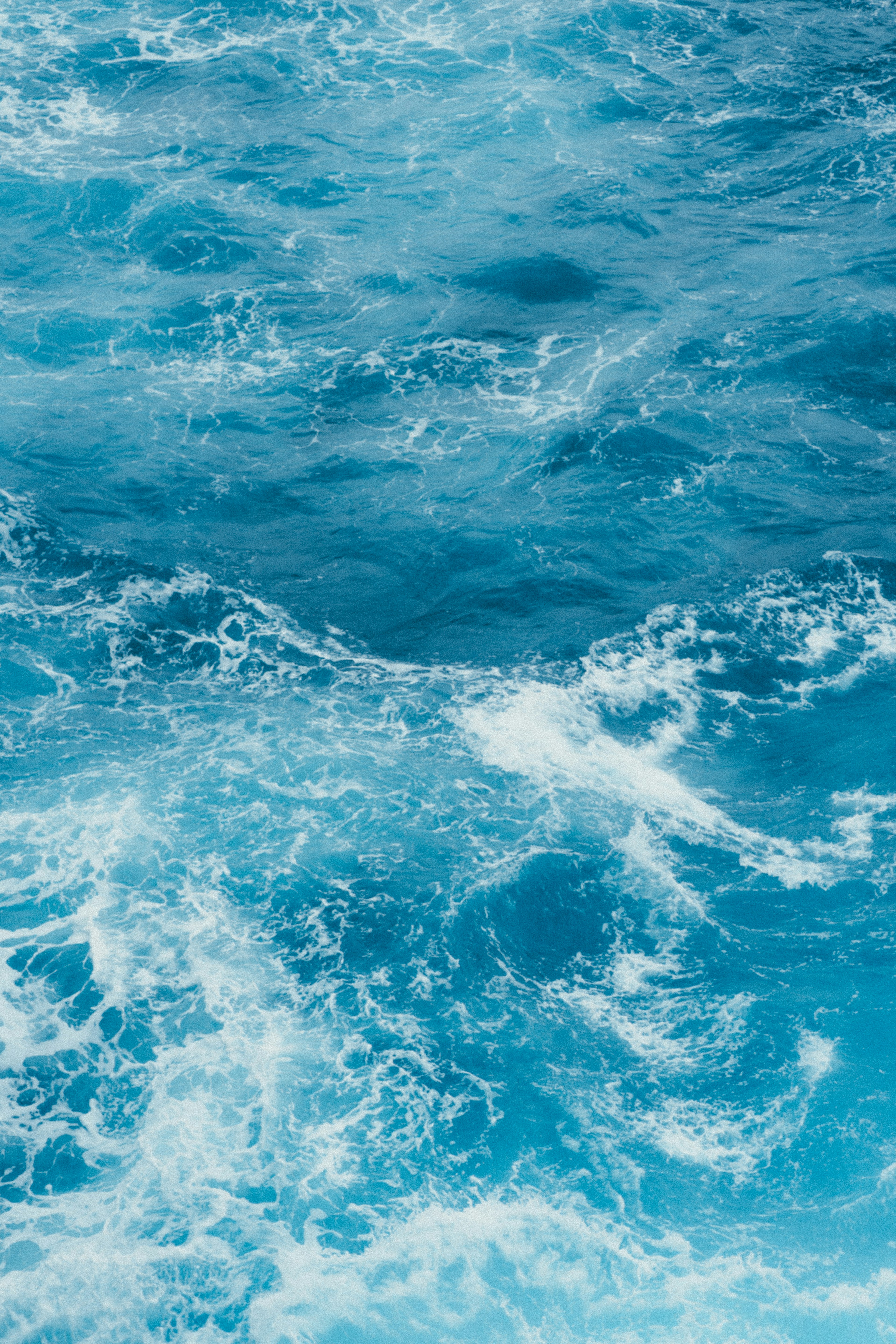 Close-up of blue ocean waves and foam