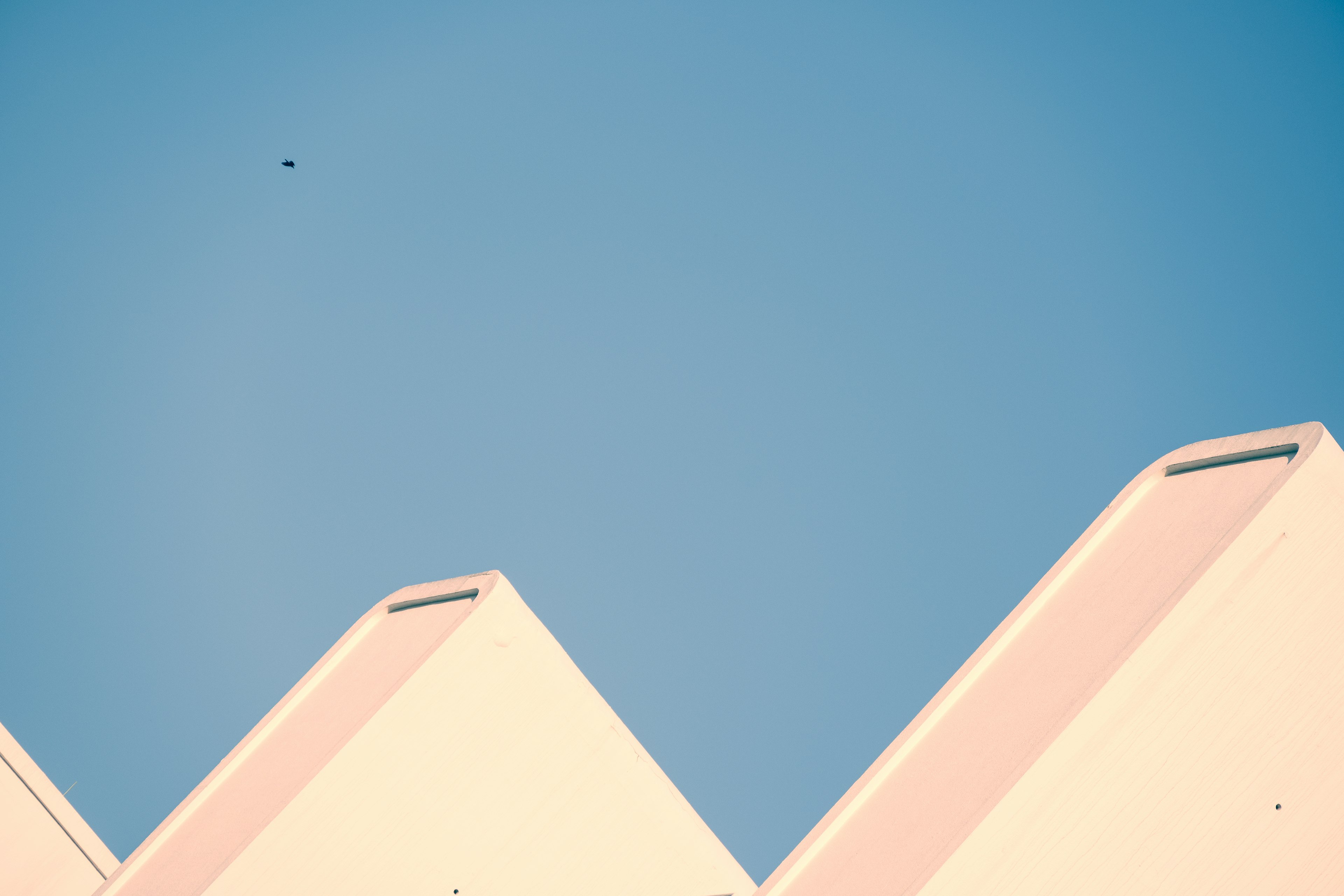 White triangular roofs against a blue sky