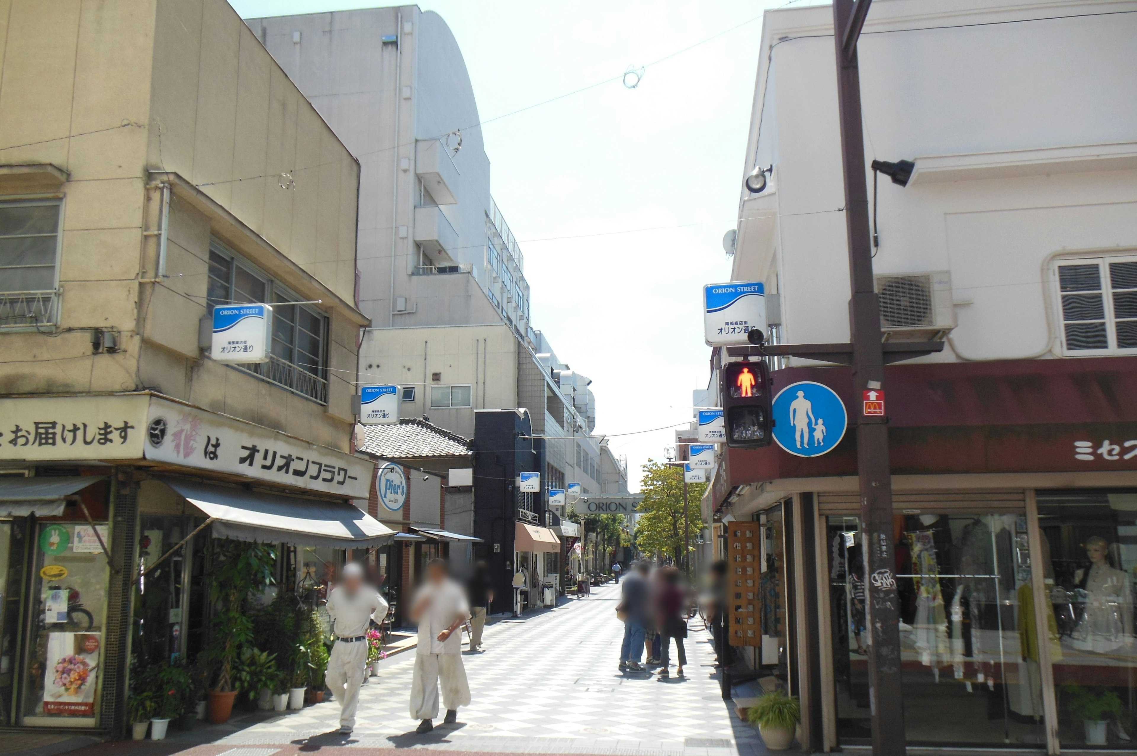 Busy street scene with shops and pedestrians