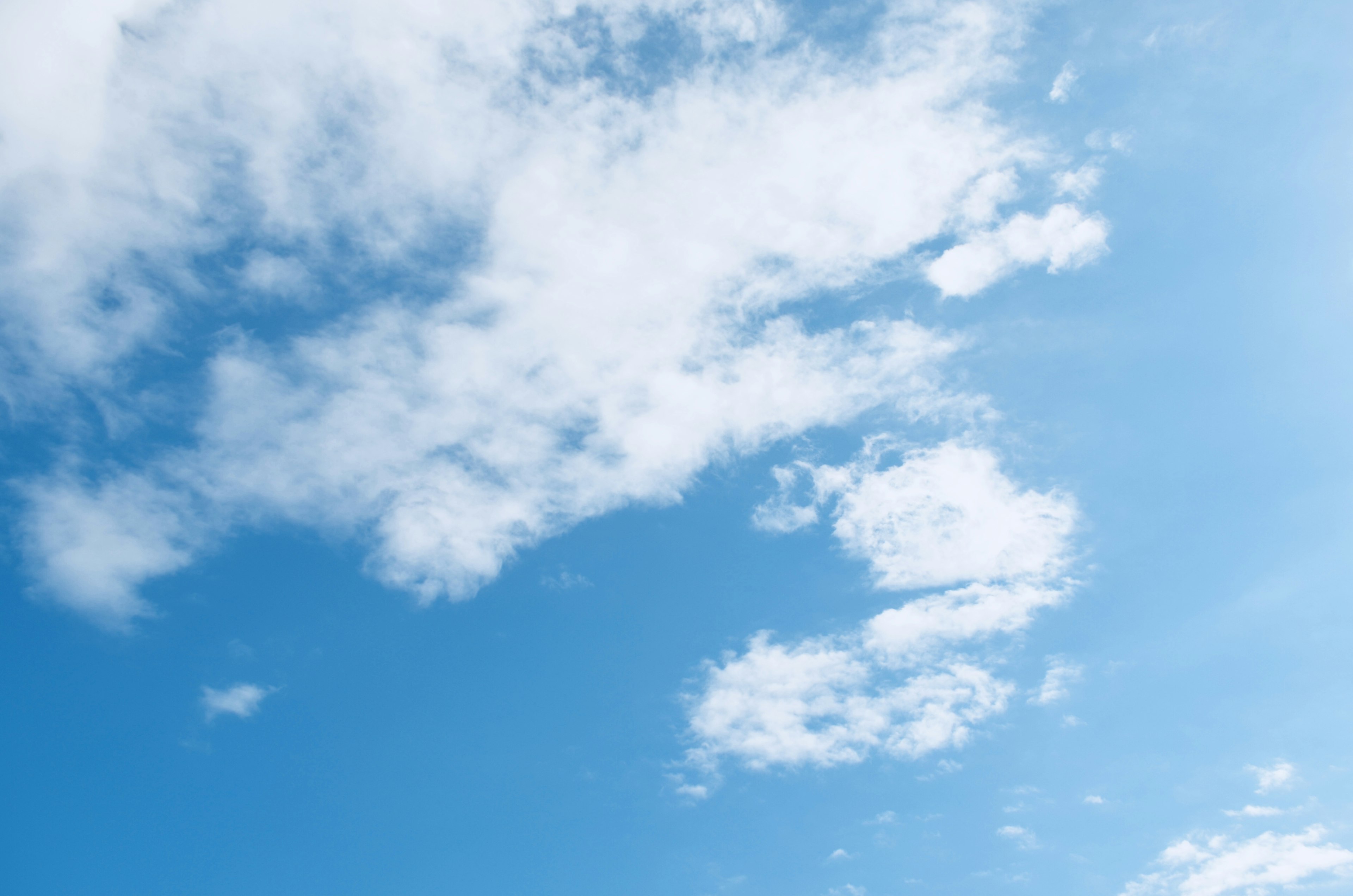 Expansive blue sky with fluffy white clouds