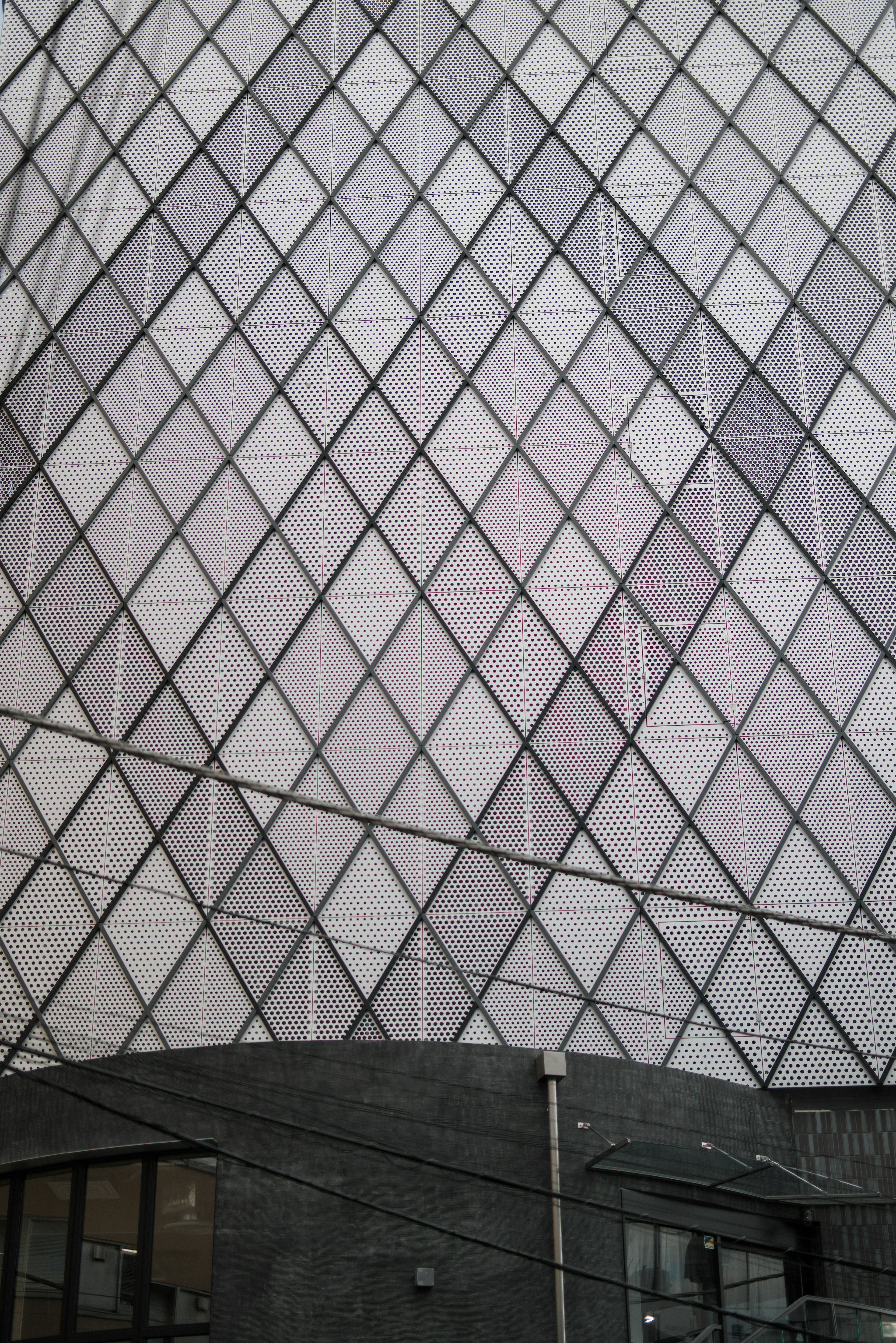 Section of a modern building featuring a diamond pattern in white and gray