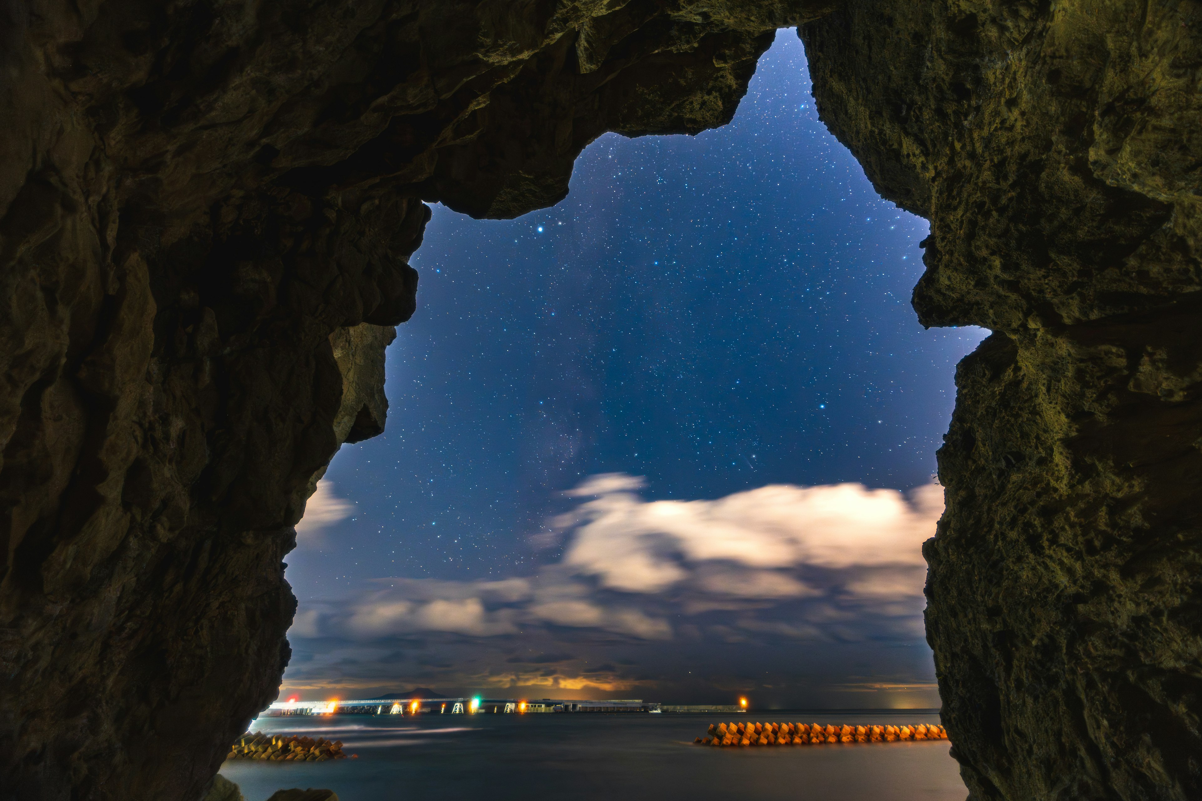 View of the starry sky and sea from a cave