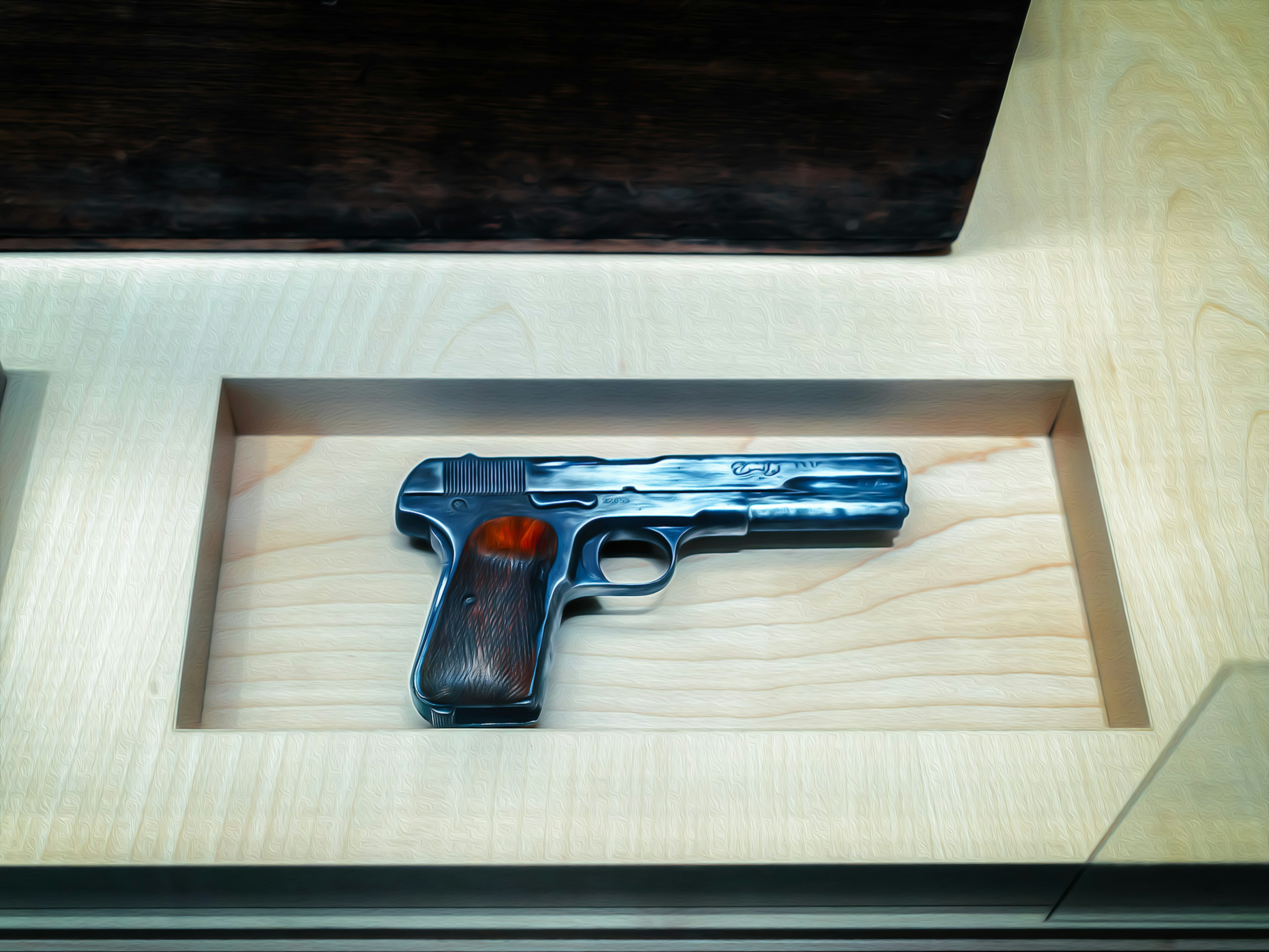 A model of a gun displayed in a case with a blue metallic barrel and wooden grip