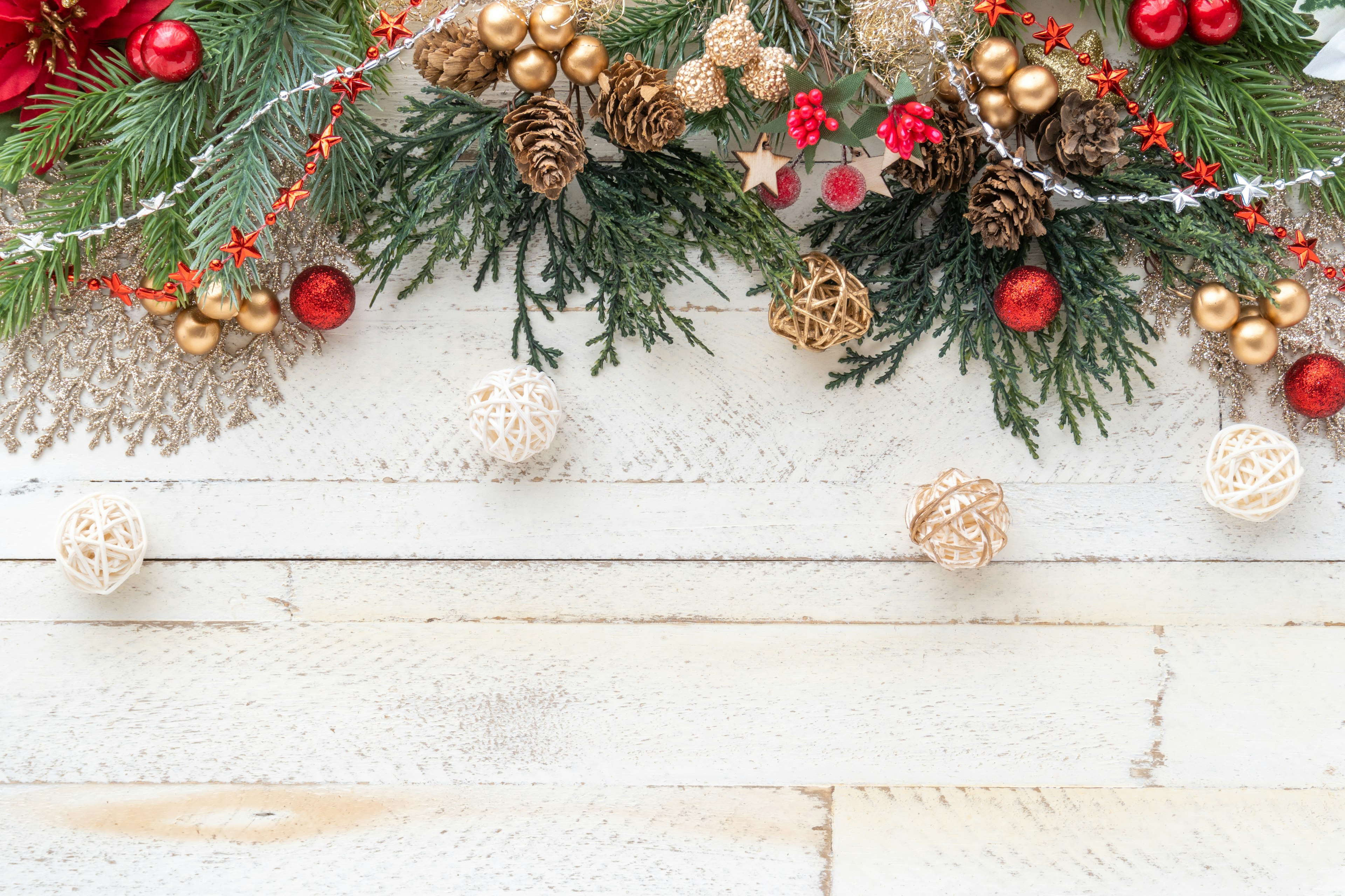 Image featuring Christmas decorations with green leaves and red berries