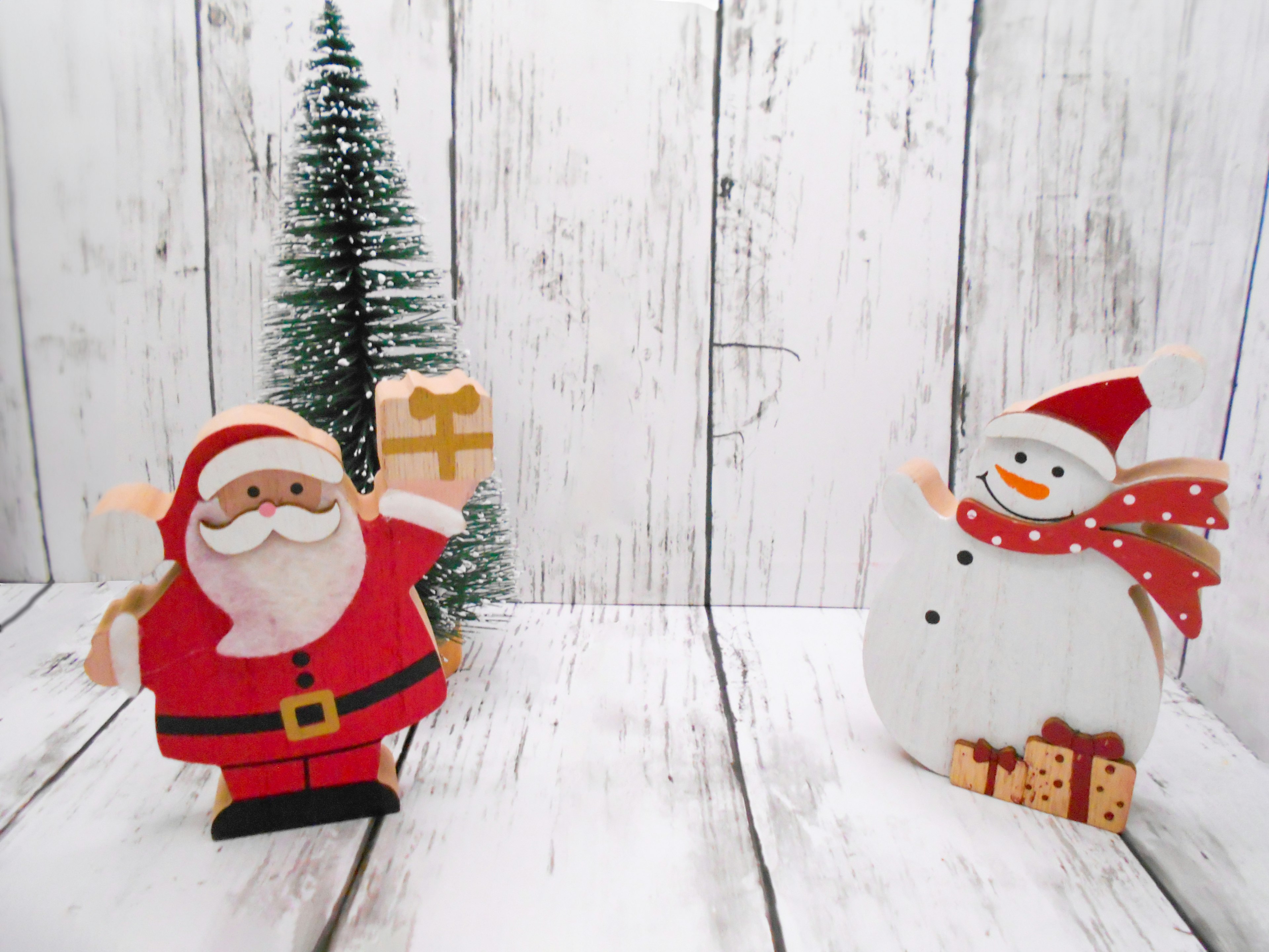 Christmas scene featuring Santa Claus and a snowman decoration