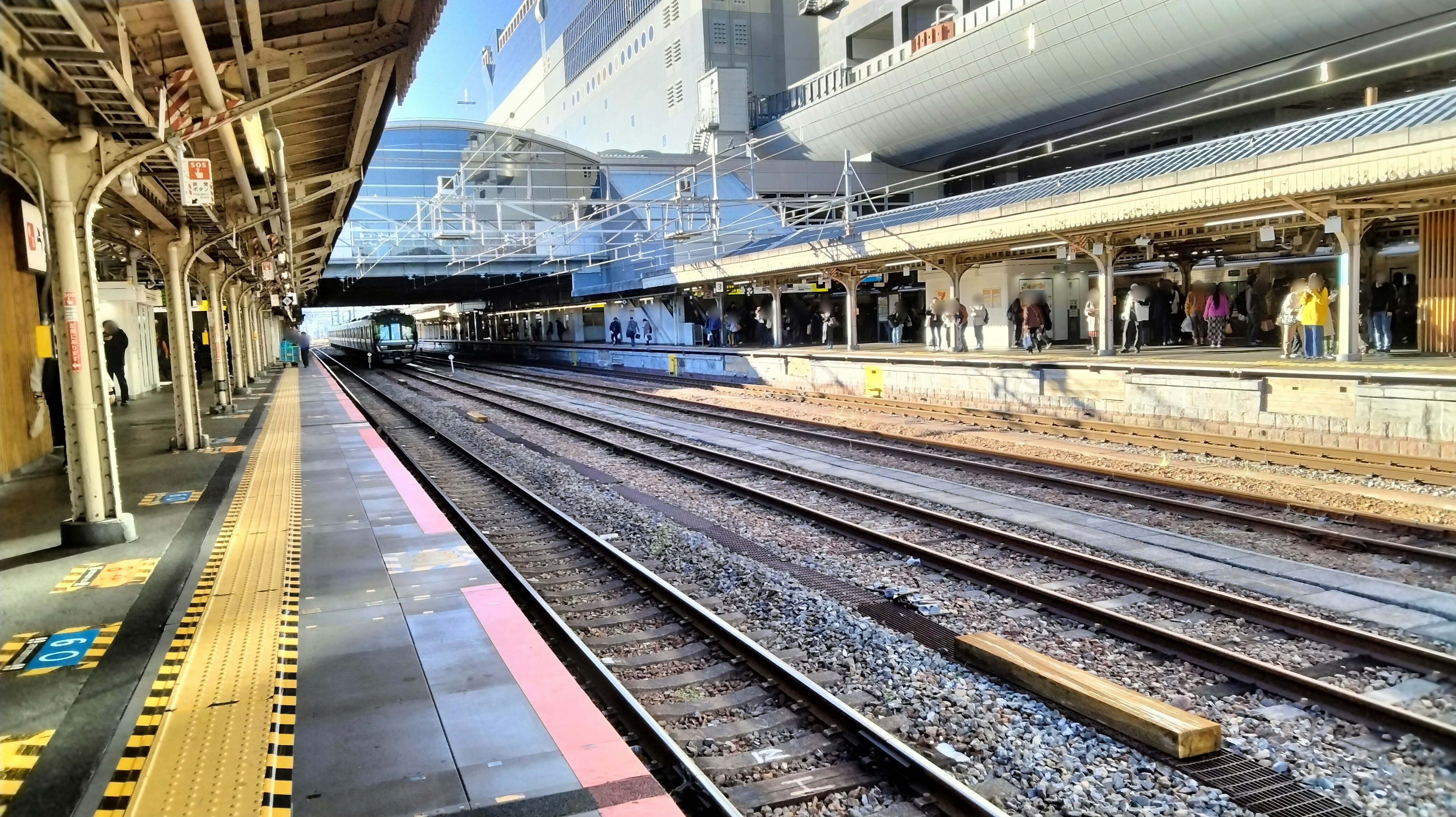 View of a train station platform with tracks