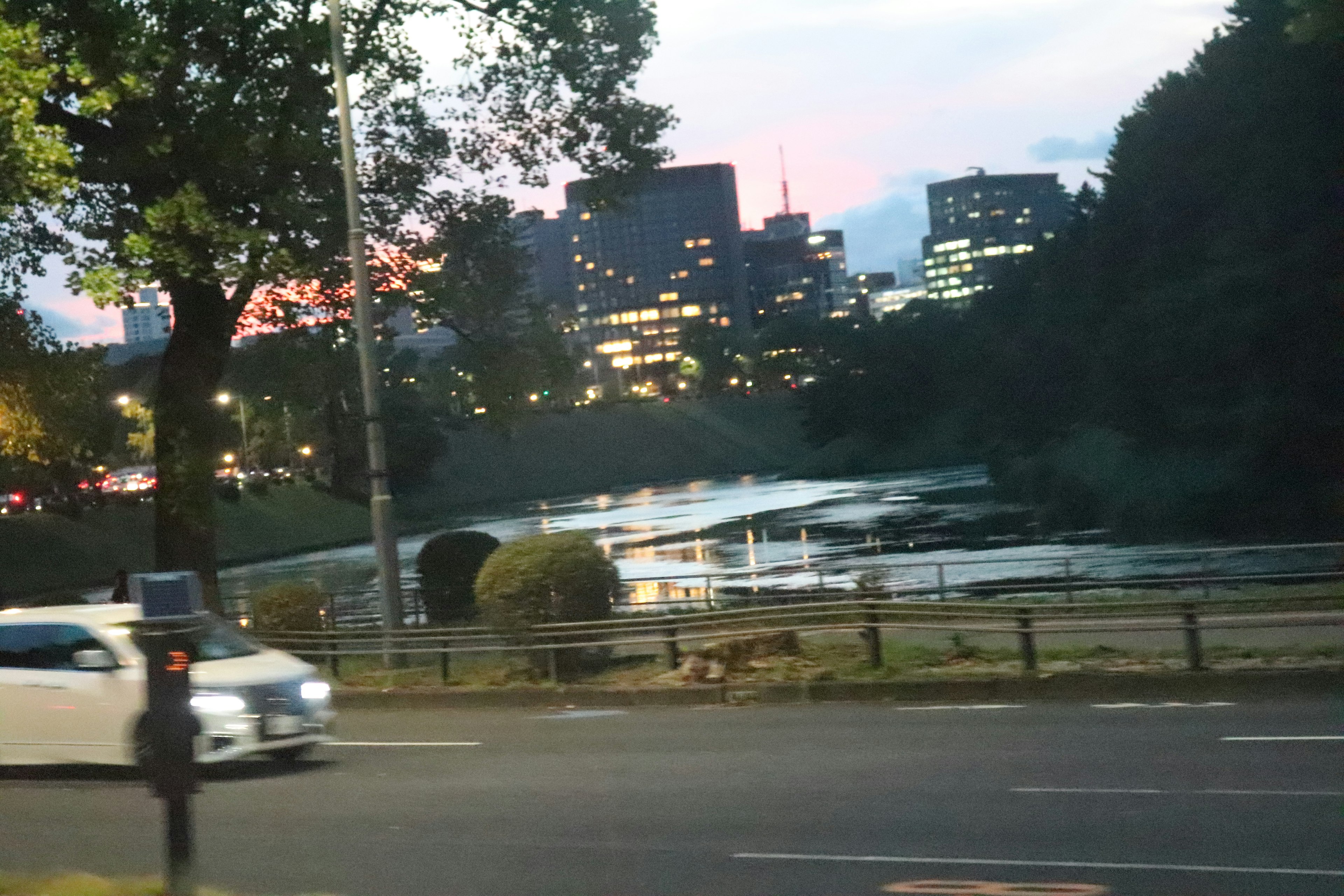 Cityscape at dusk featuring buildings and a river