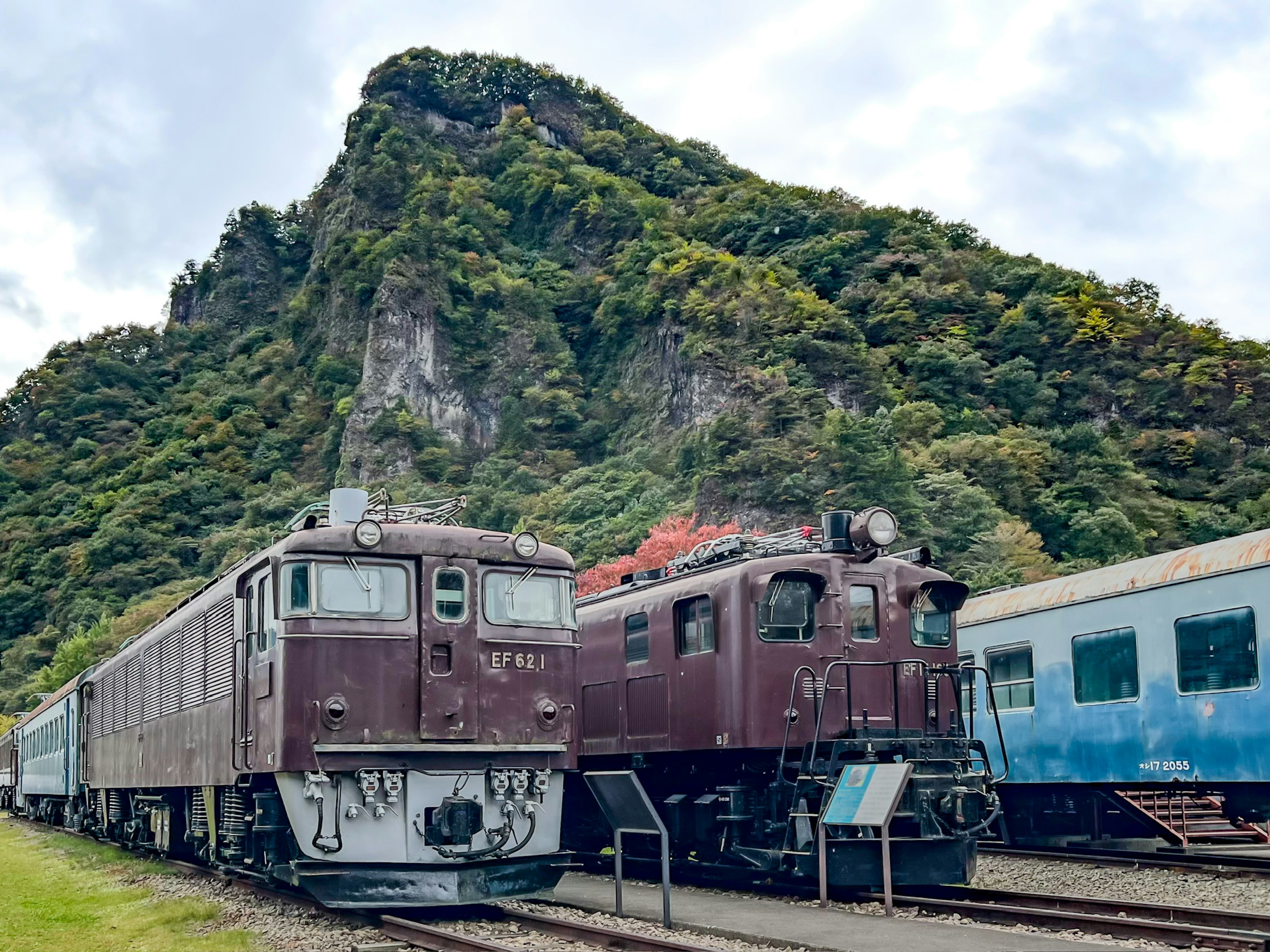 Scenic view of vintage trains near a mountain