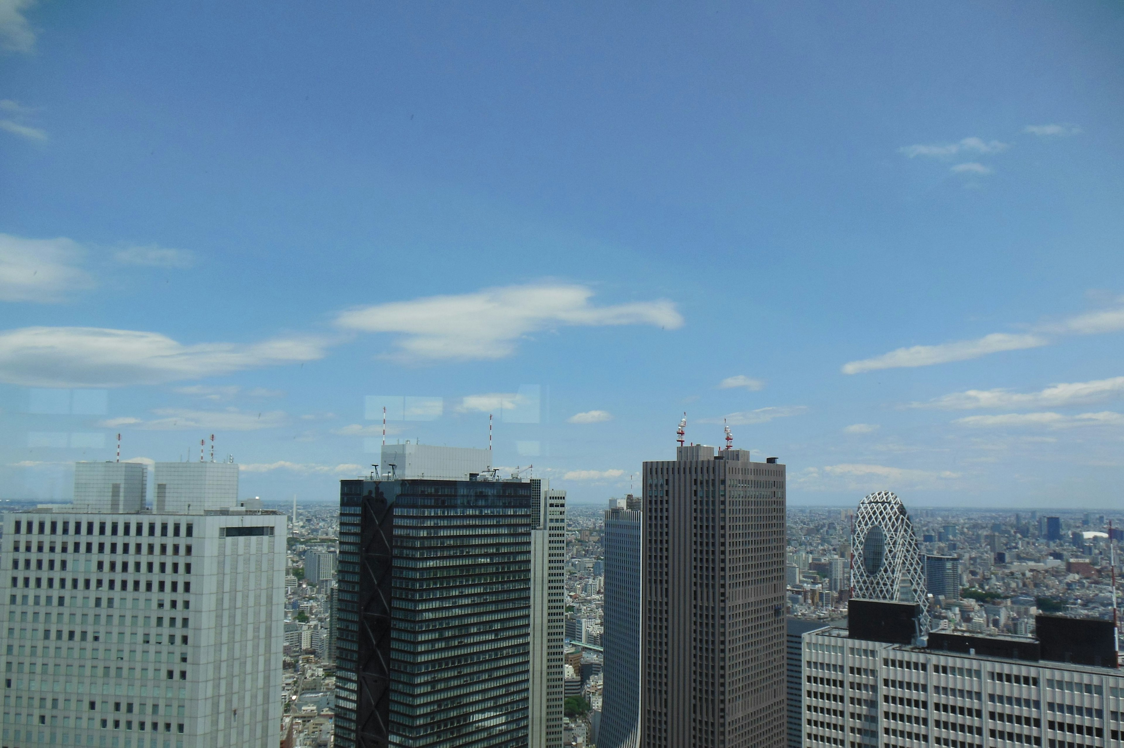 Pemandangan kota dengan gedung tinggi di bawah langit biru yang cerah