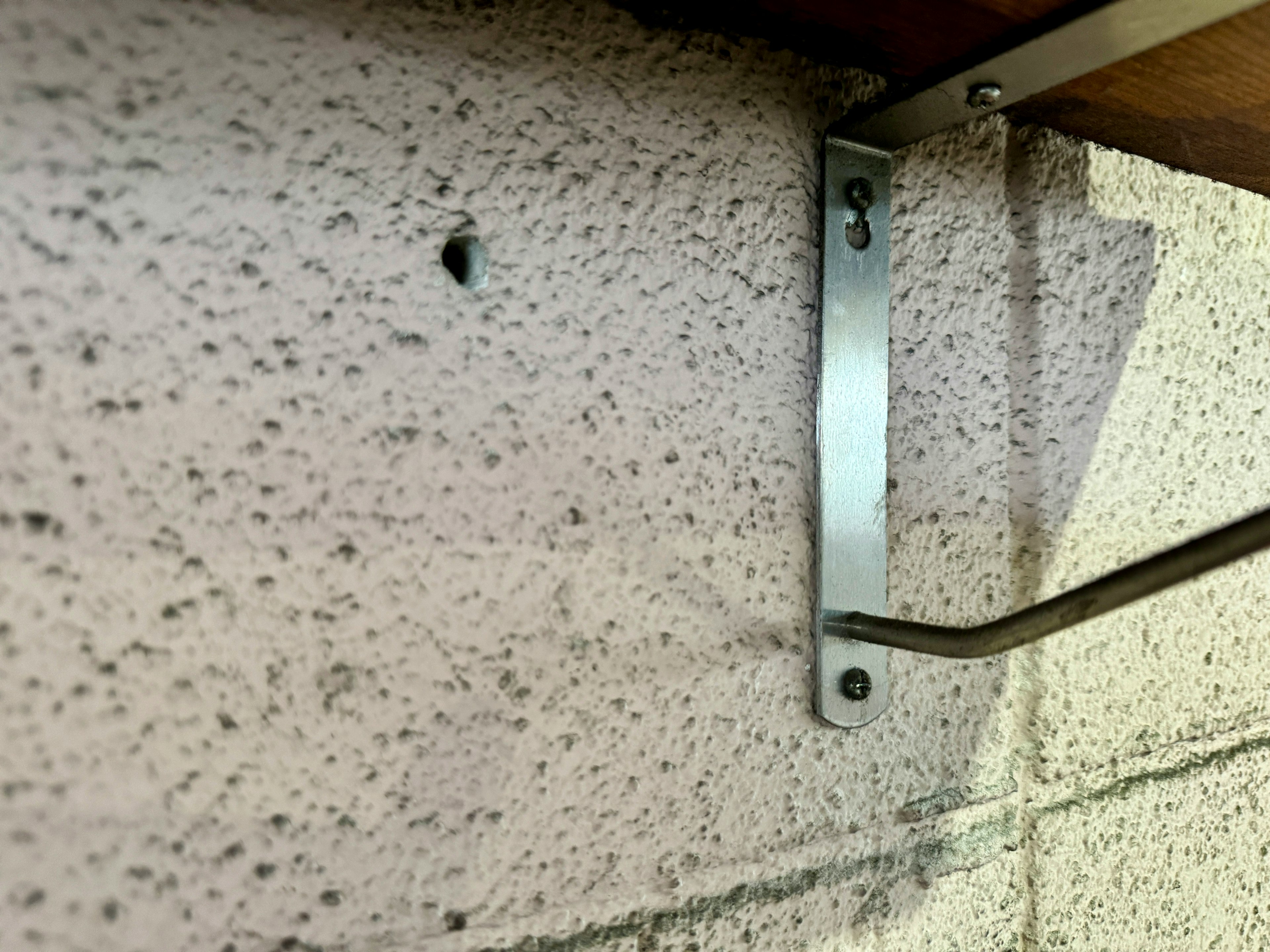 Metal bracket attached to a concrete wall