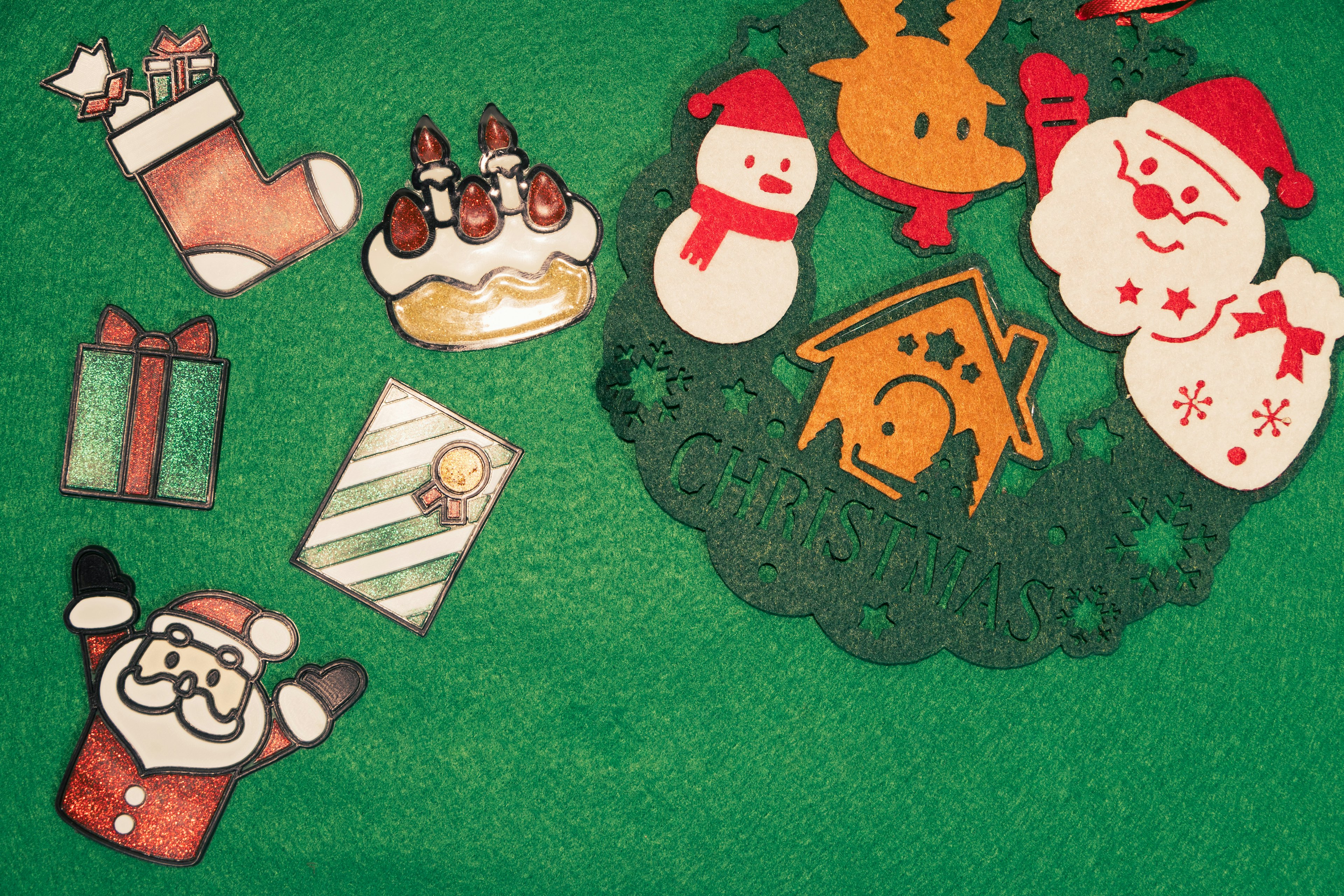 A festive display of Christmas cookies and ornaments on a green background