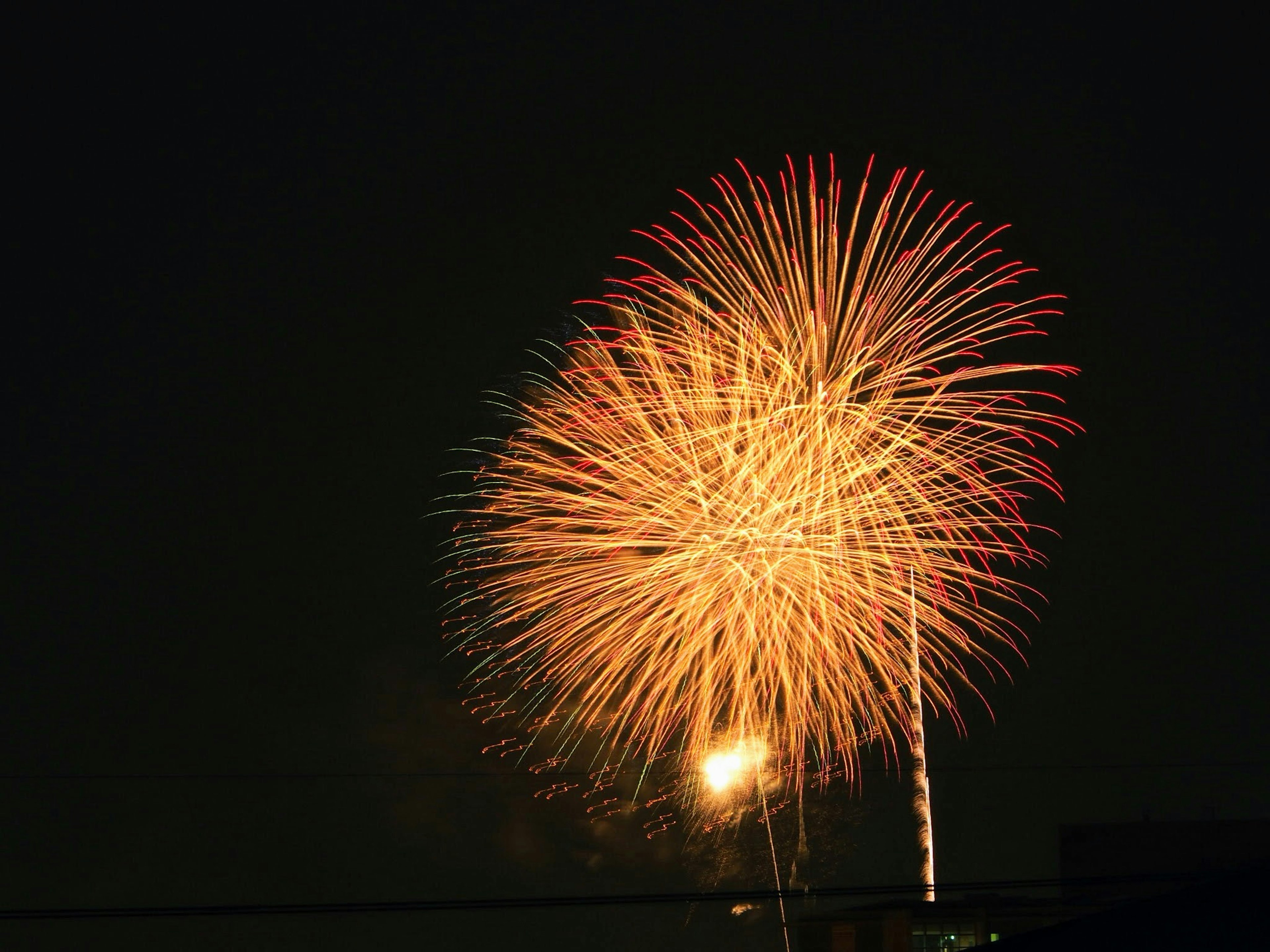 Large fireworks display bursting in the night sky