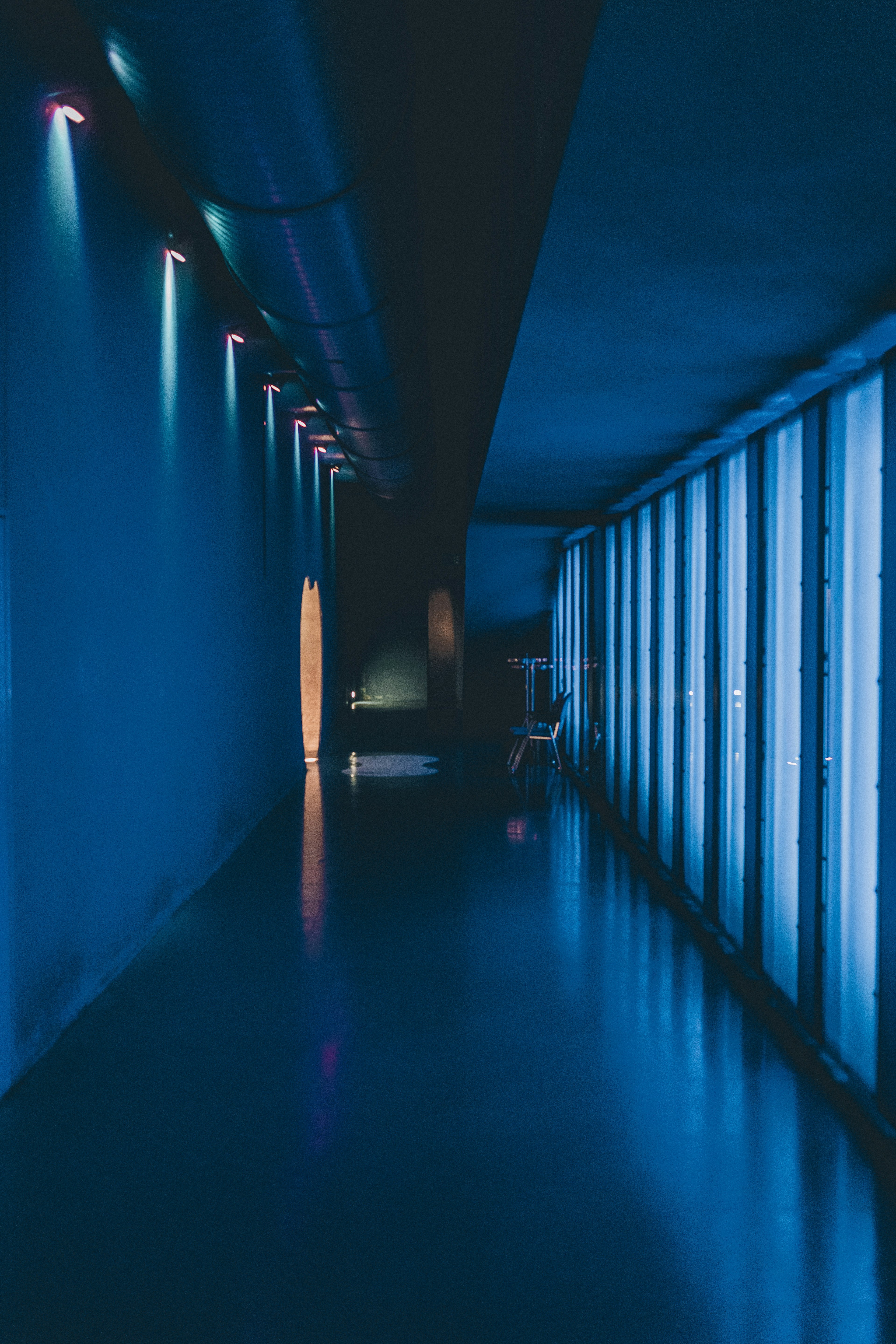 A corridor illuminated by striking blue lighting