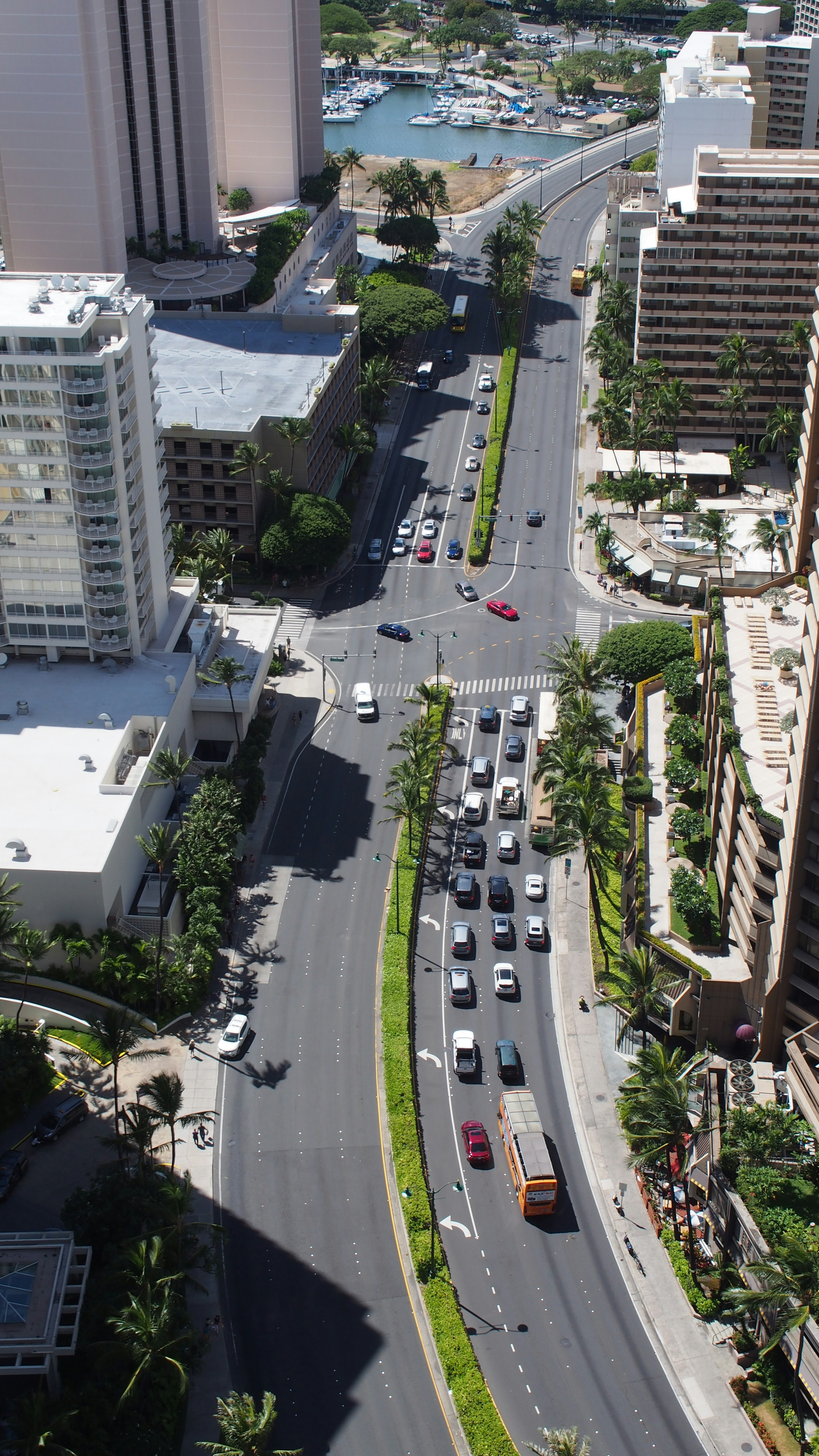 Aerial view of a Hawaiian cityscape with high-rise buildings and visible traffic