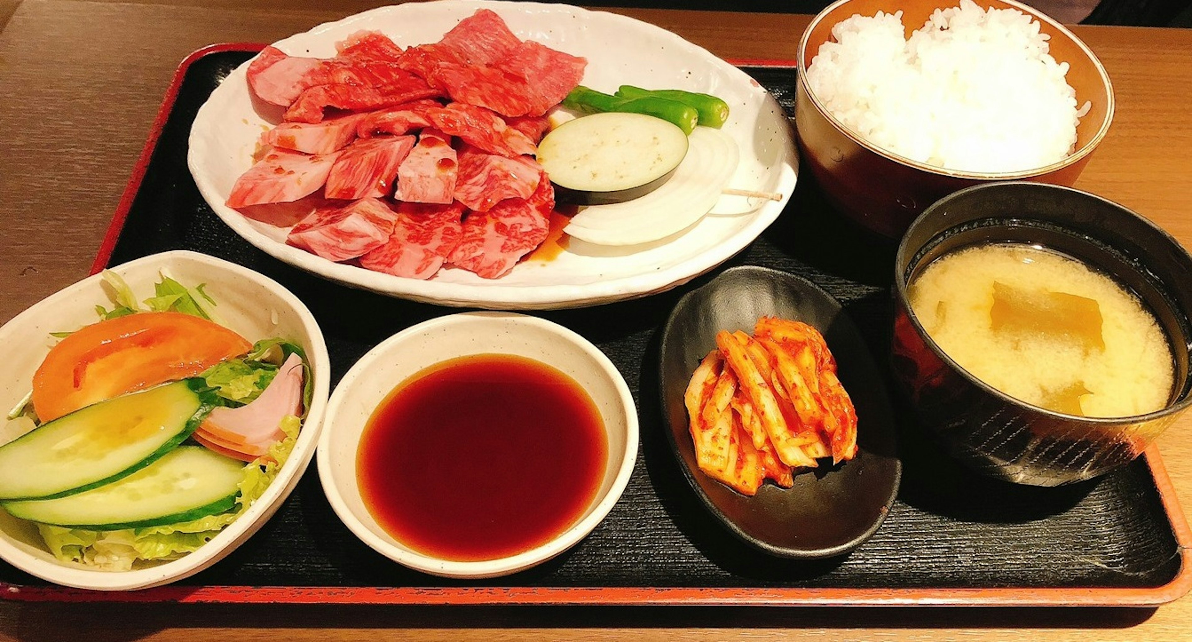 Grilled meat platter with rice and side dishes