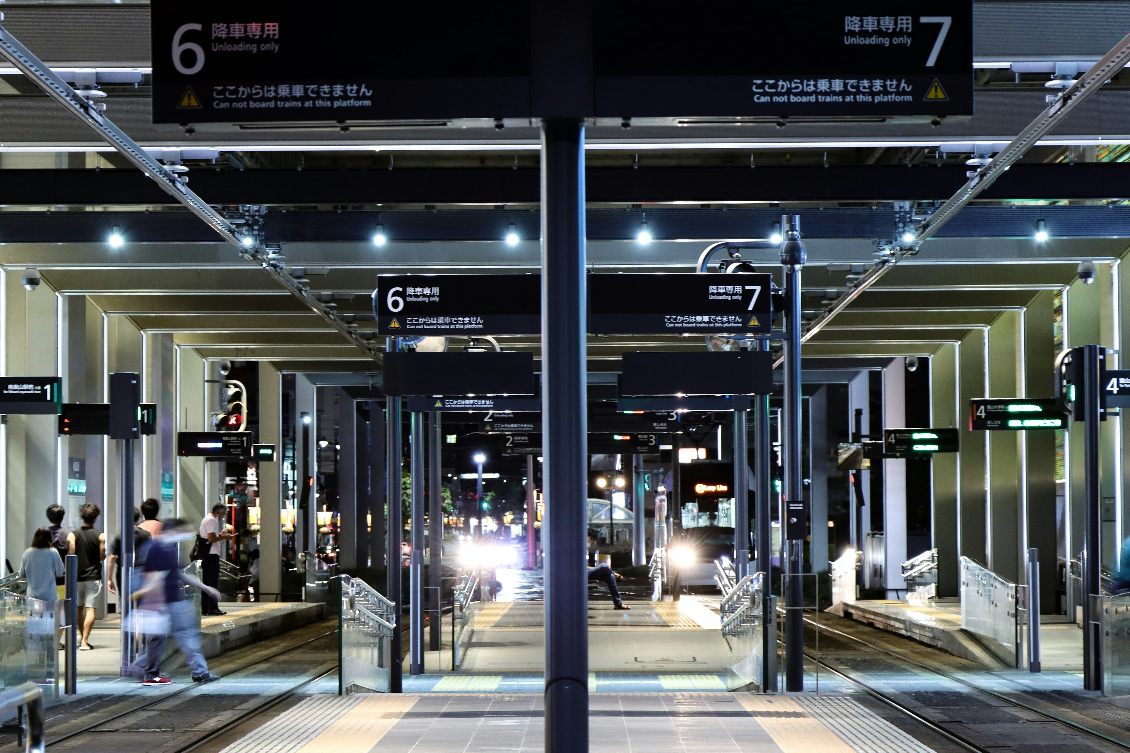 Night view of train platform with numbered signs