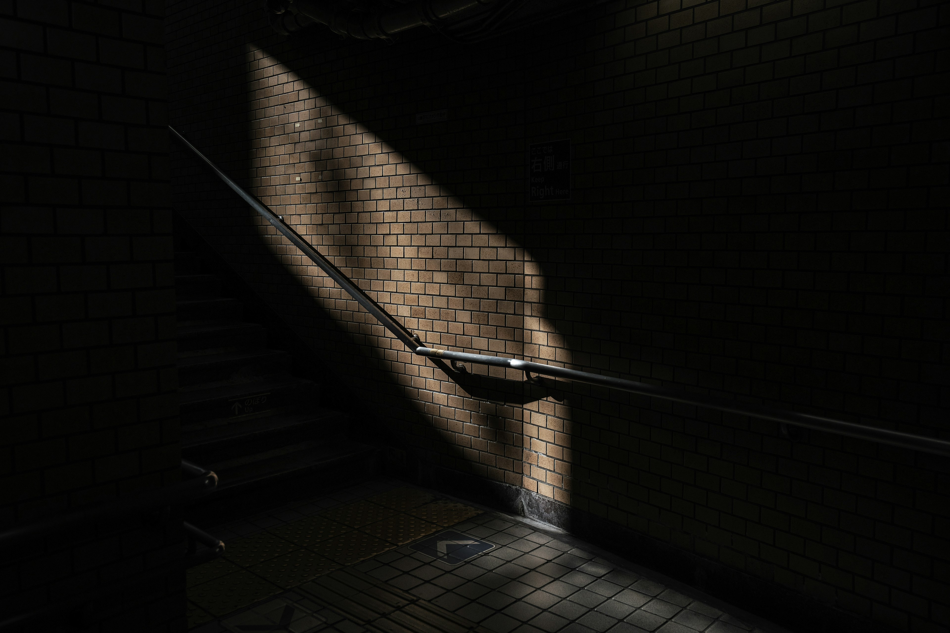 Contrast of light and shadow on a dark staircase